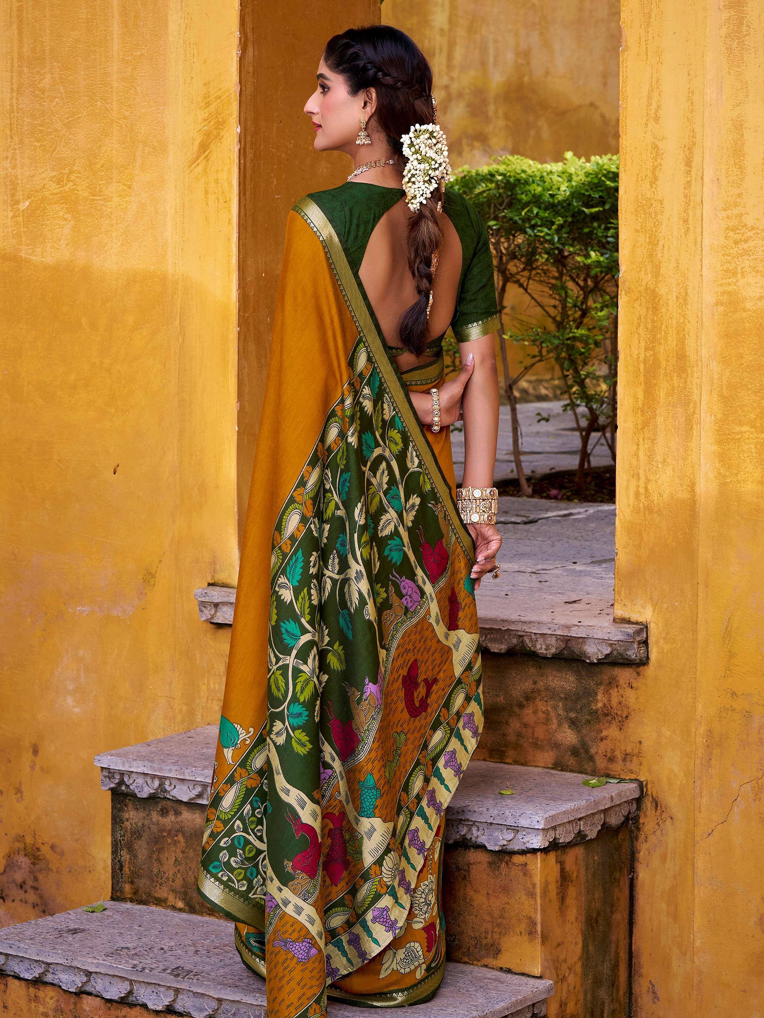 Woman in green and mustard printed saree with floral motifs, traditional Indian ethnic wear