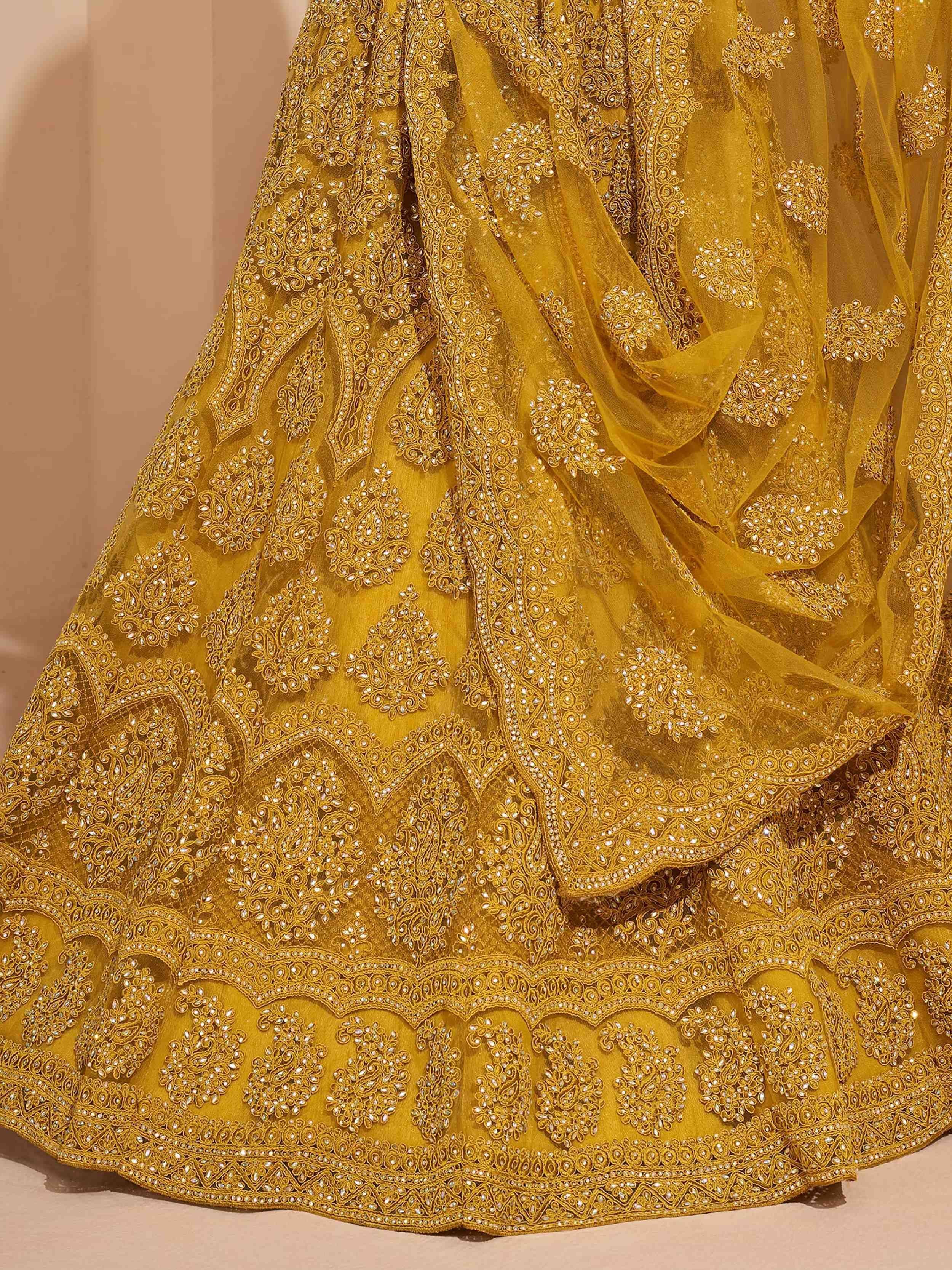 Golden embroidered lehenga choli with intricate zari and stone work, perfect for Indian ethnic occasions.