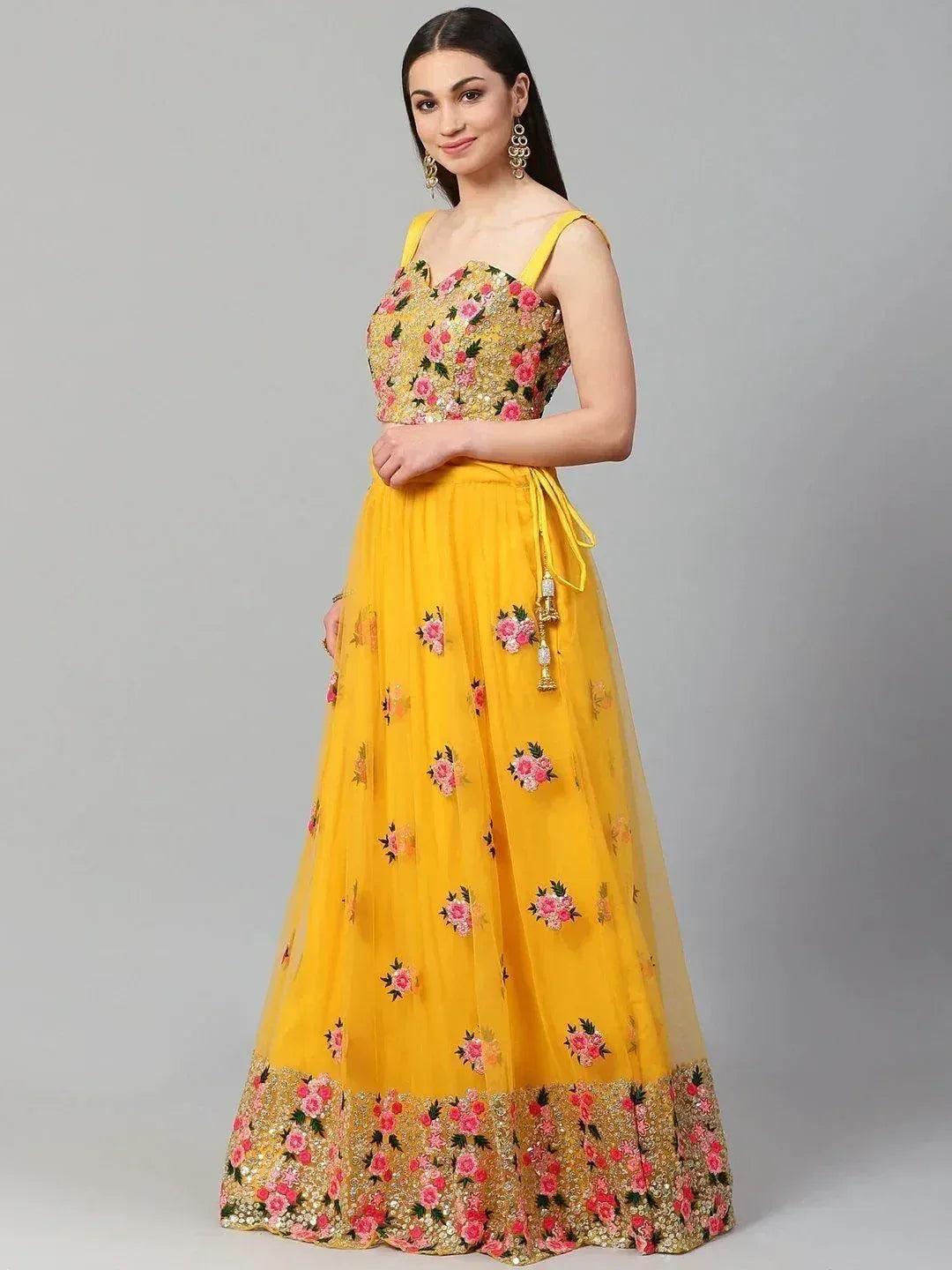Yellow floral embroidered lehenga choli with pink roses and gold detailing, perfect for Indian ethnic wear