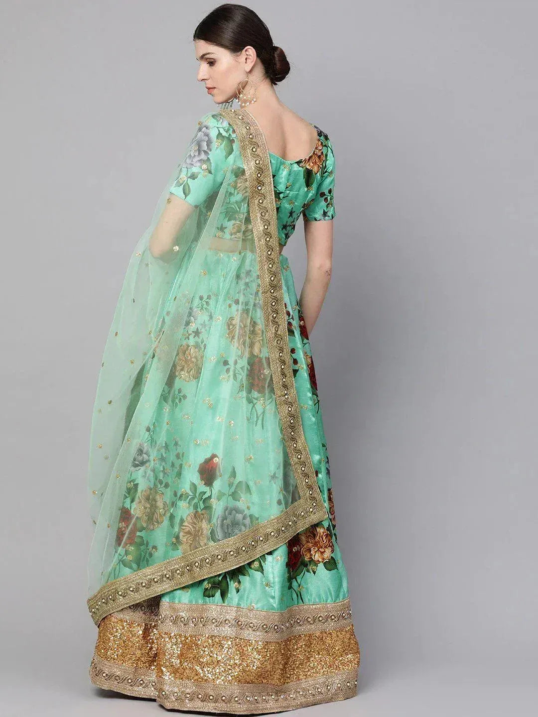 Mint green floral lehenga choli with gold embroidery and sequin border, perfect for Indian ethnic occasions