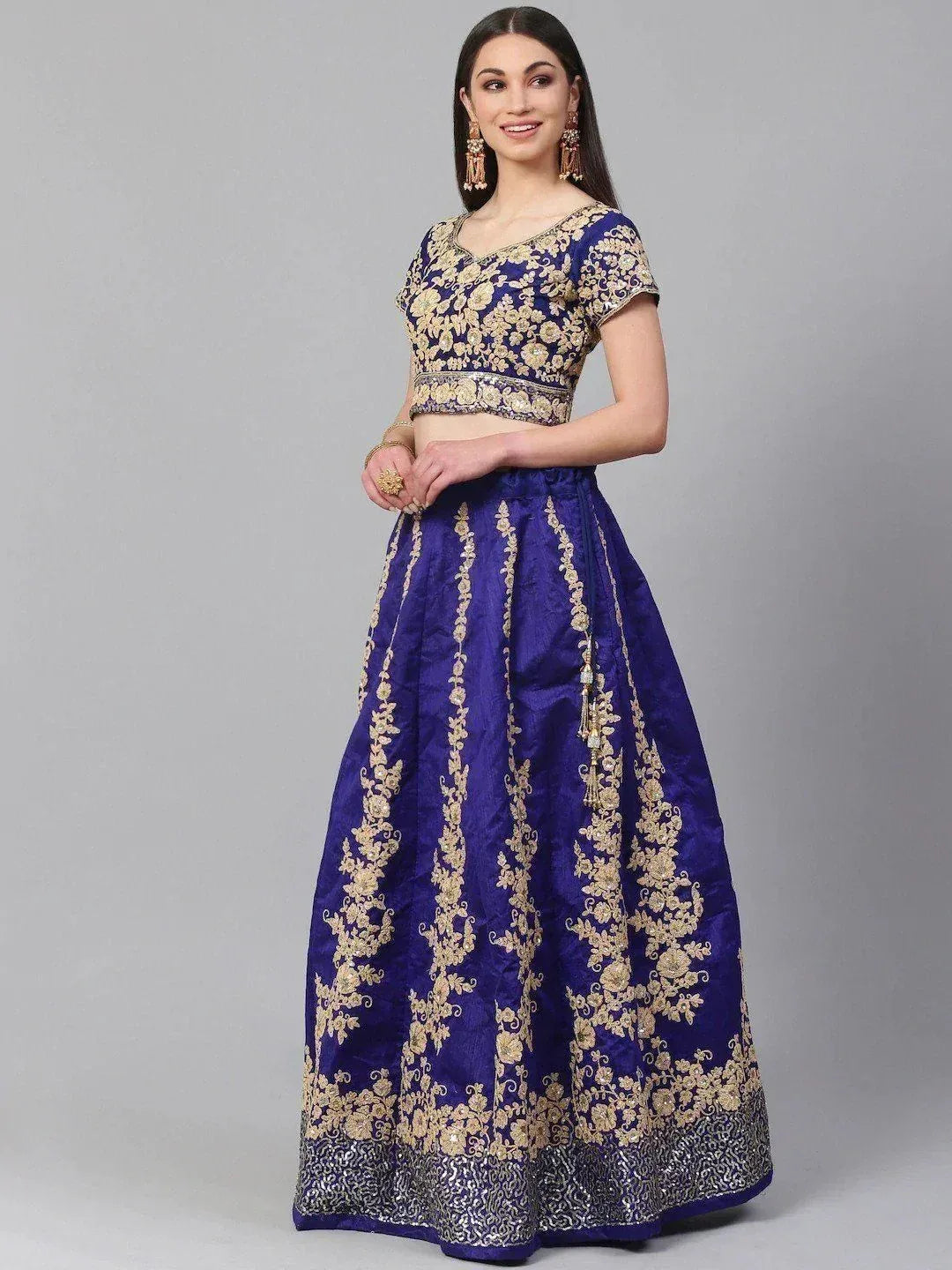 Royal blue lehenga choli with gold floral embroidery, perfect for weddings and festive occasions.