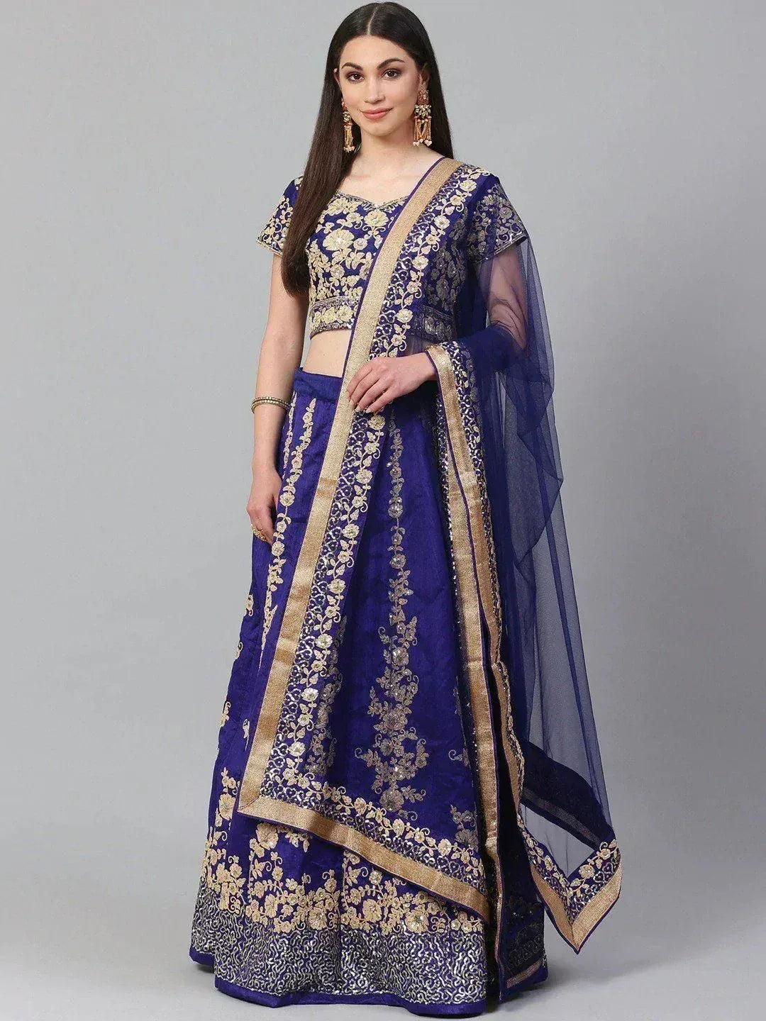 Royal blue embroidered lehenga choli with gold floral work and sheer dupatta, perfect for Indian weddings and festive occasions