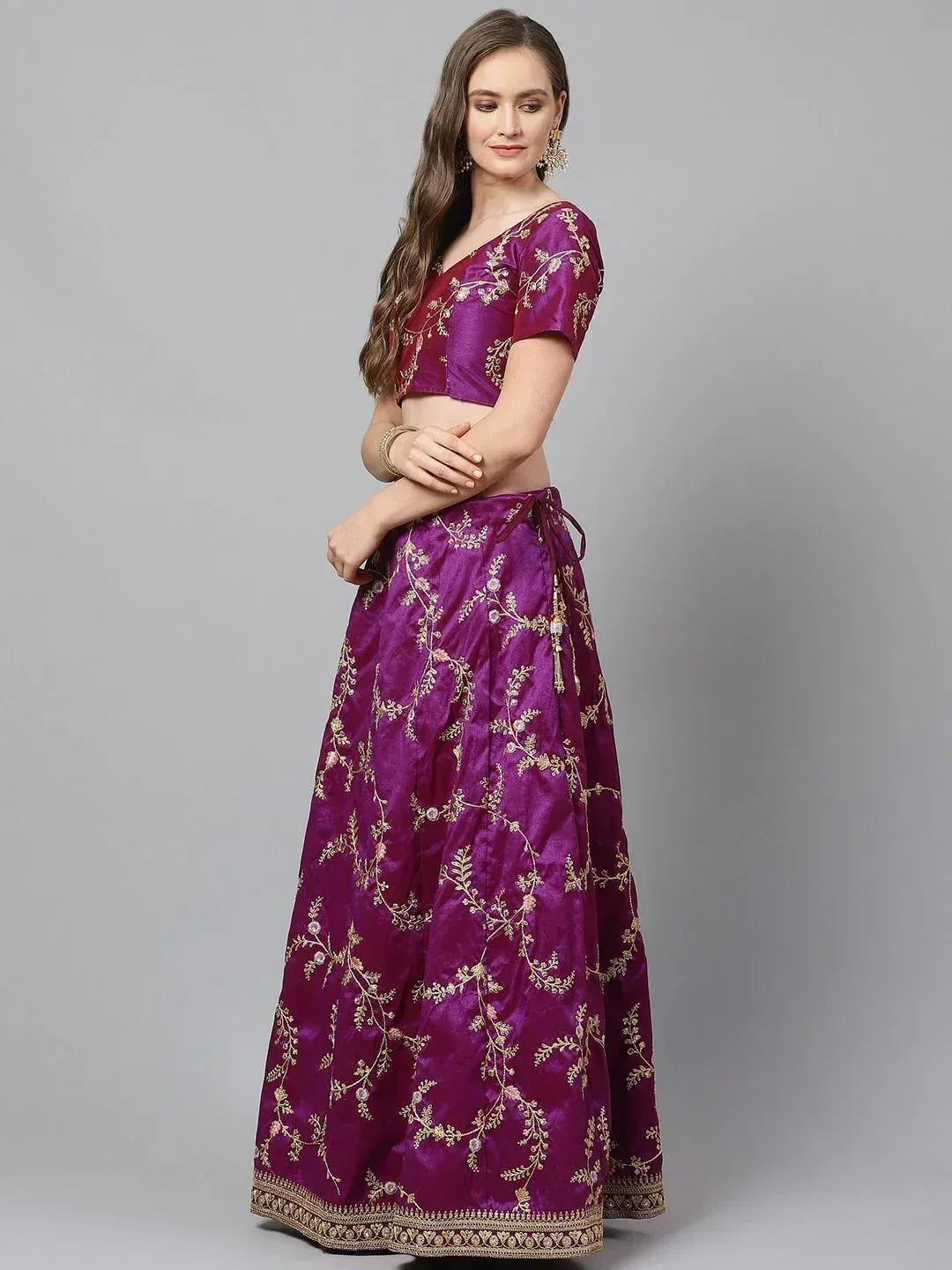 Purple embroidered lehenga choli with gold floral detailing, perfect for Indian ethnic wear occasions