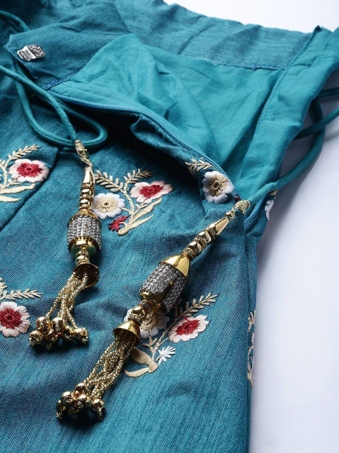 Teal ethnic top with floral embroidery and gold tassels, perfect for Indian wear