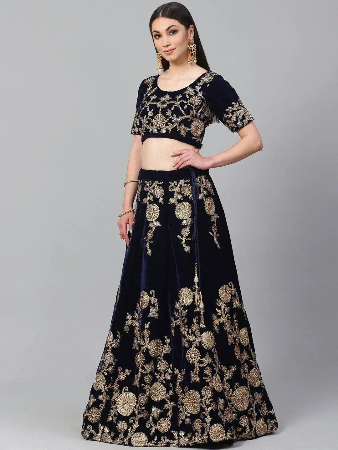 Navy blue velvet lehenga choli with gold floral embroidery, perfect for Indian ethnic occasions