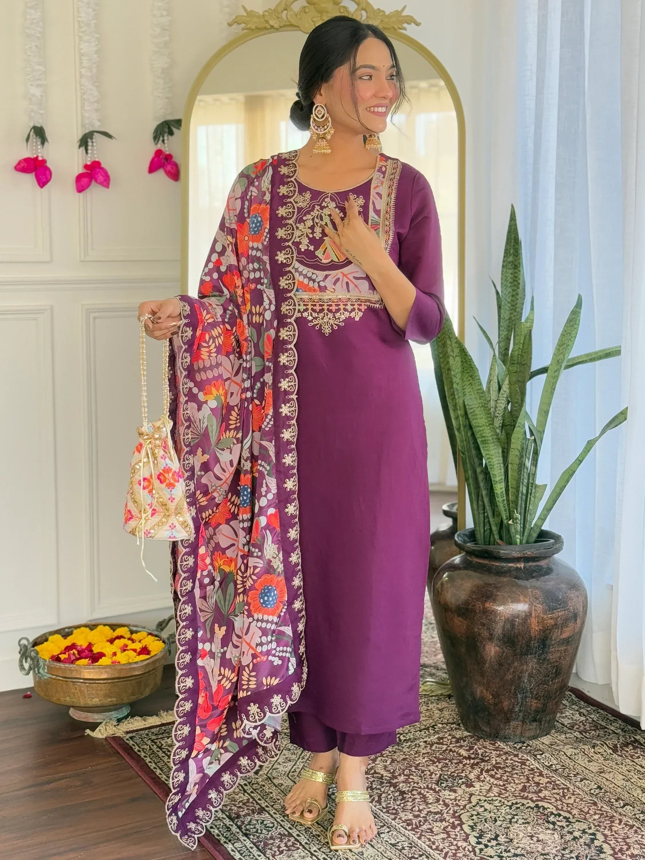 Purple embroidered ethnic kurti with floral dupatta and gold accessories