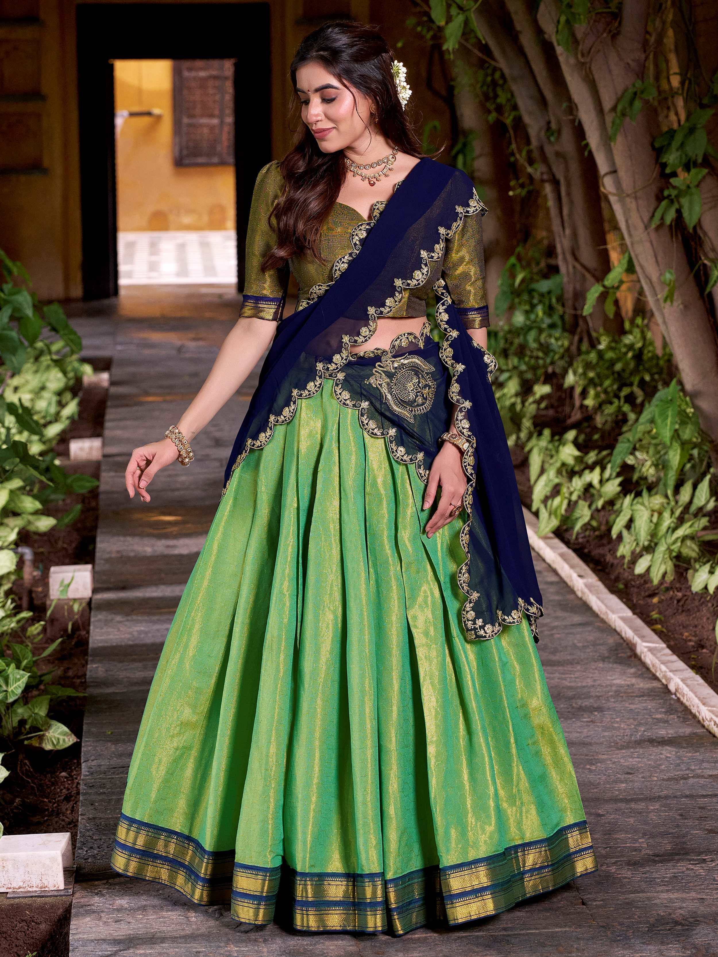 Green and navy blue designer lehenga choli with gold embroidery, perfect for Indian ethnic wear.