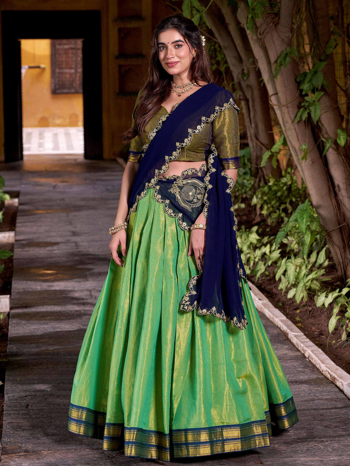 Green and navy blue designer lehenga choli with gold embroidery, perfect for Indian ethnic wear.