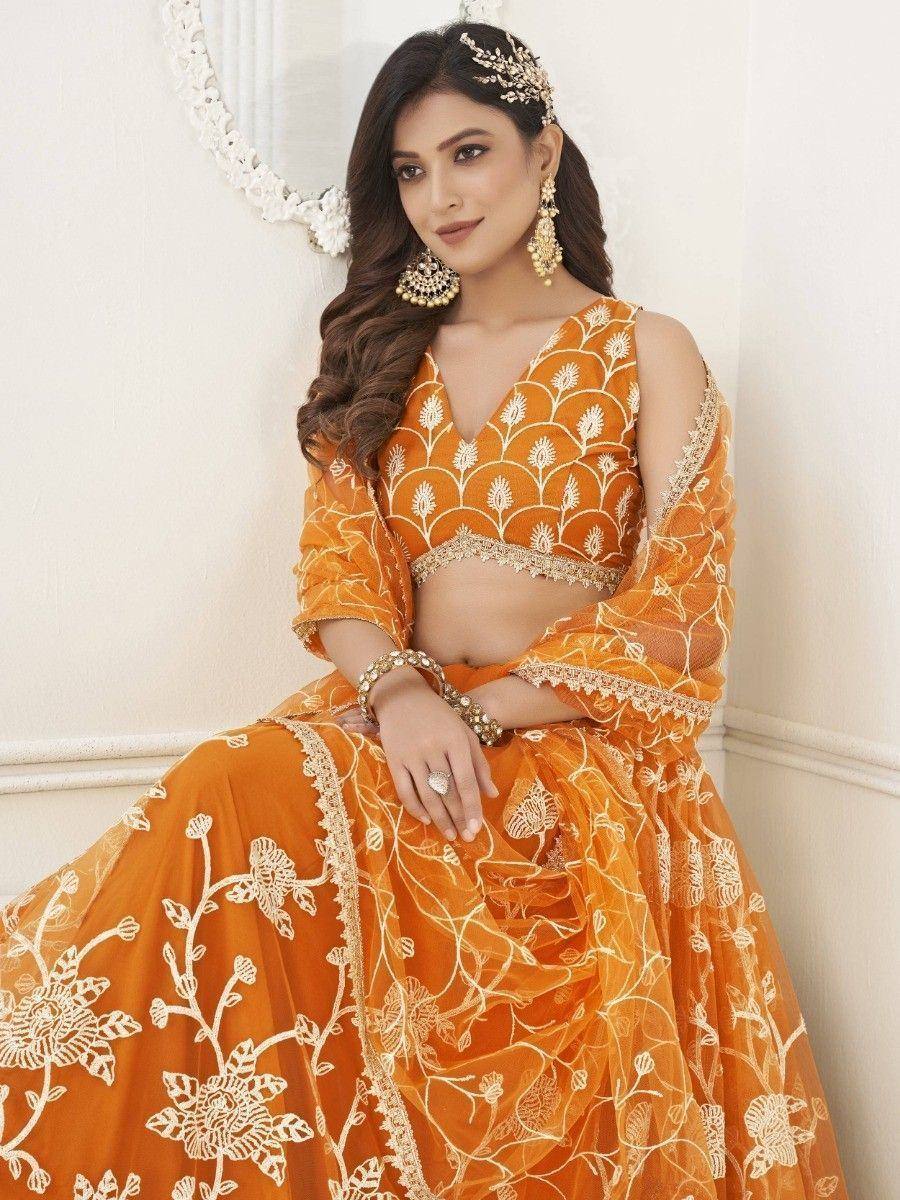 Orange embroidered lehenga choli with floral design, perfect for Indian weddings and festive occasions.