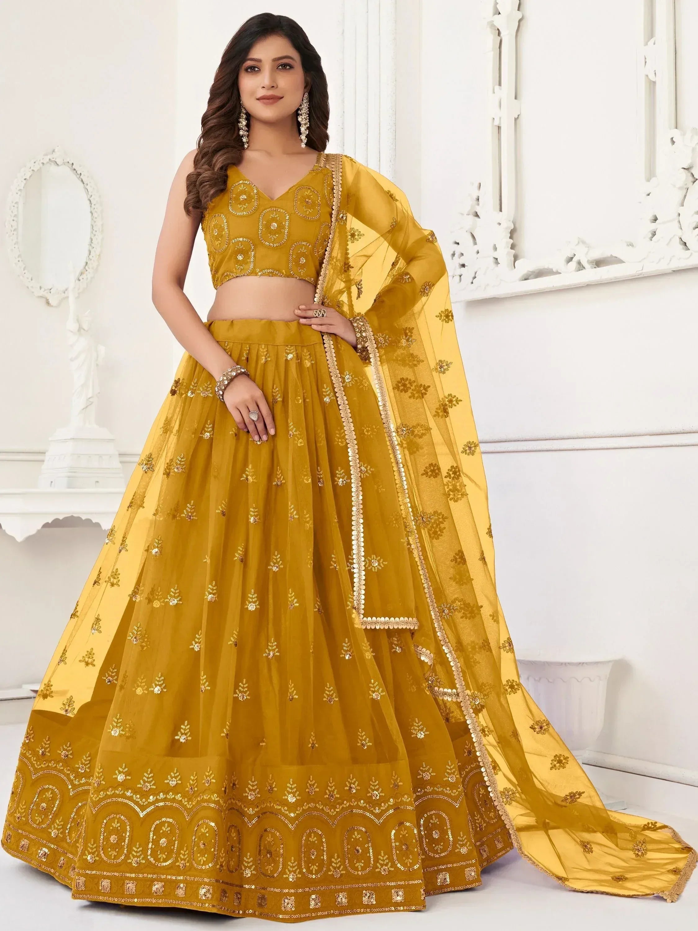 Mustard yellow embroidered lehenga choli with floral motifs and sequin detailing, perfect for Indian ethnic occasions