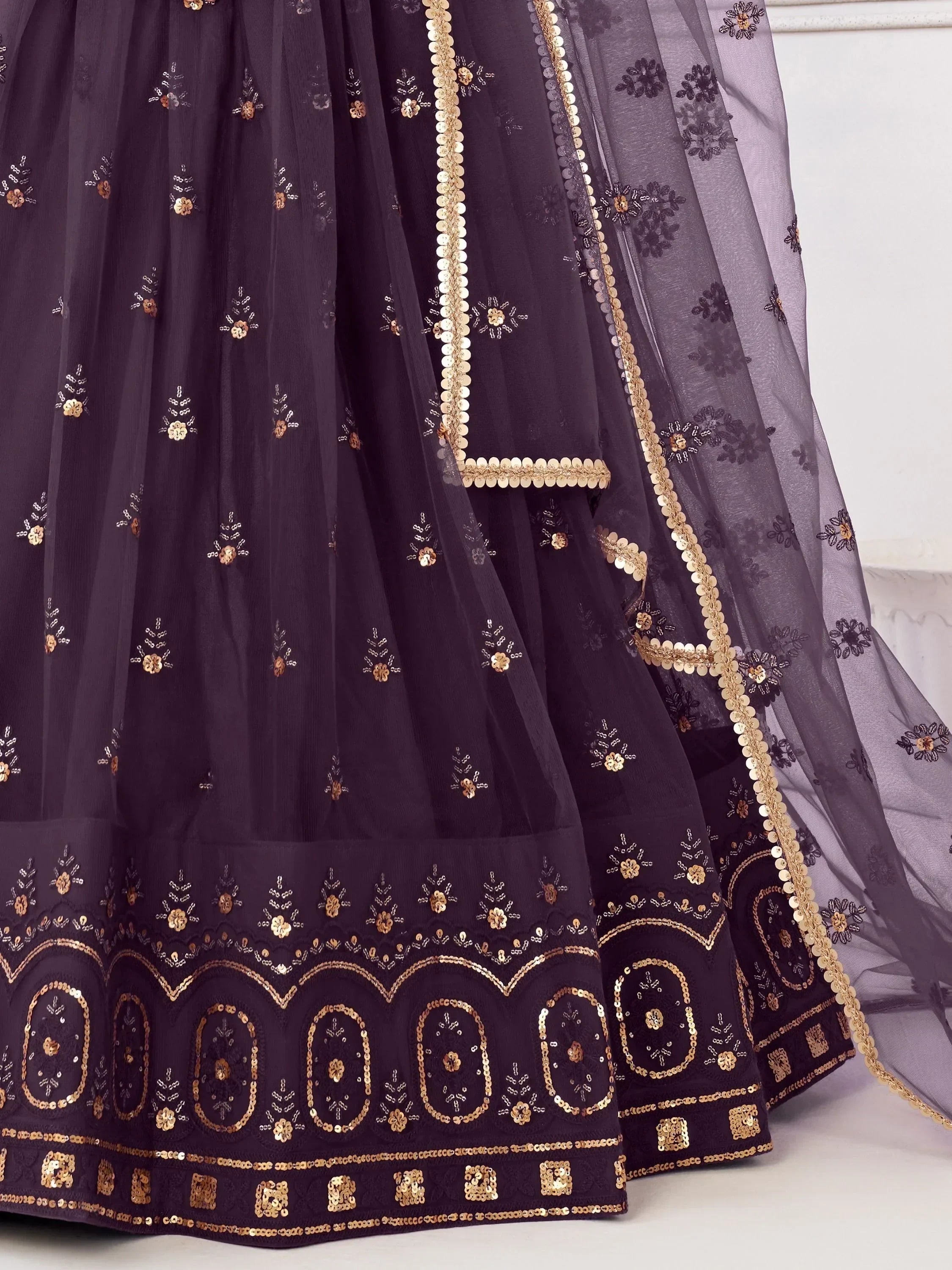 Elegant purple lehenga with gold embroidery and sequin detailing, perfect for Indian ethnic wear.