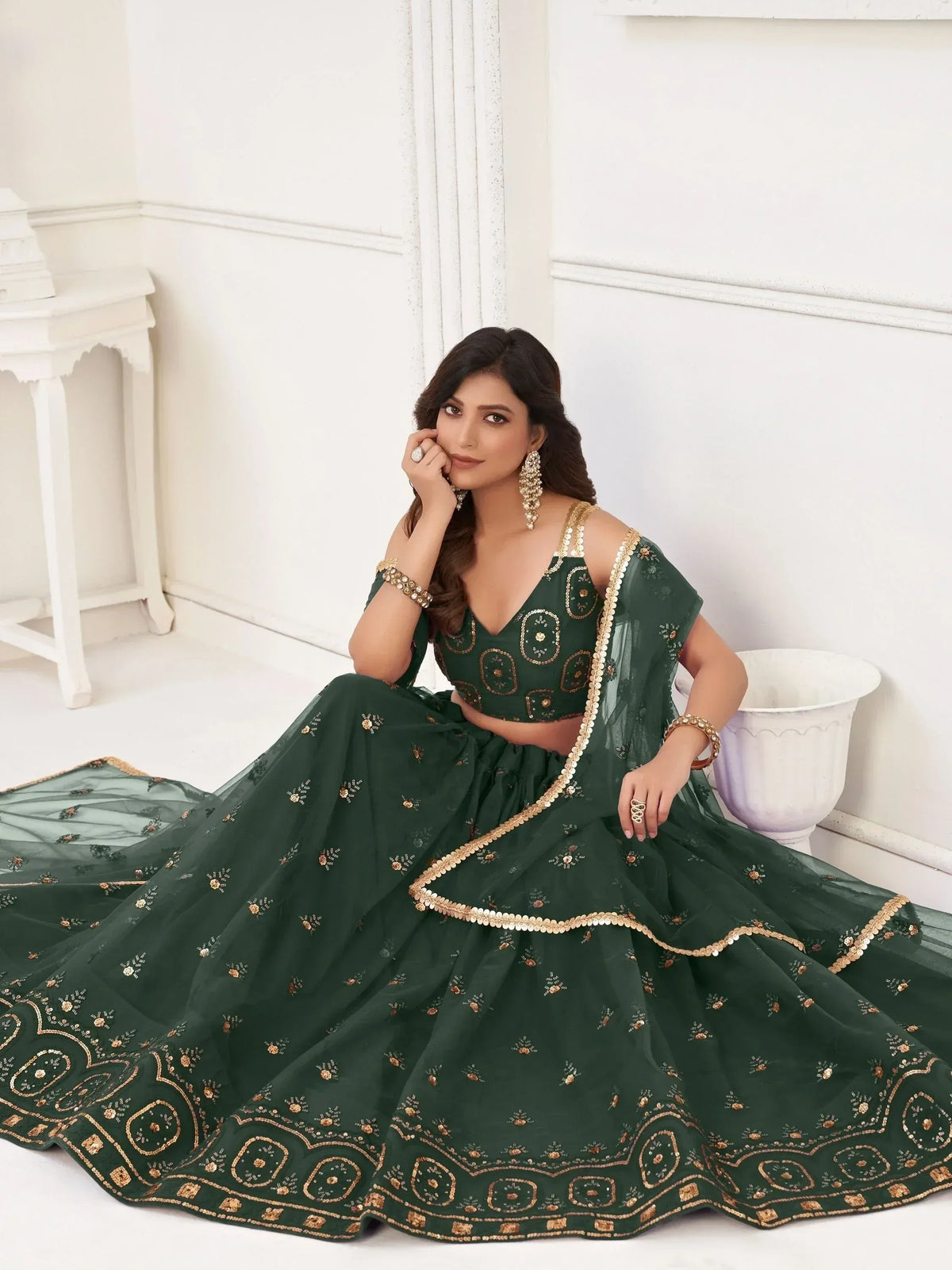 Elegant green designer lehenga choli with gold embroidery, perfect for Indian weddings and festive occasions.