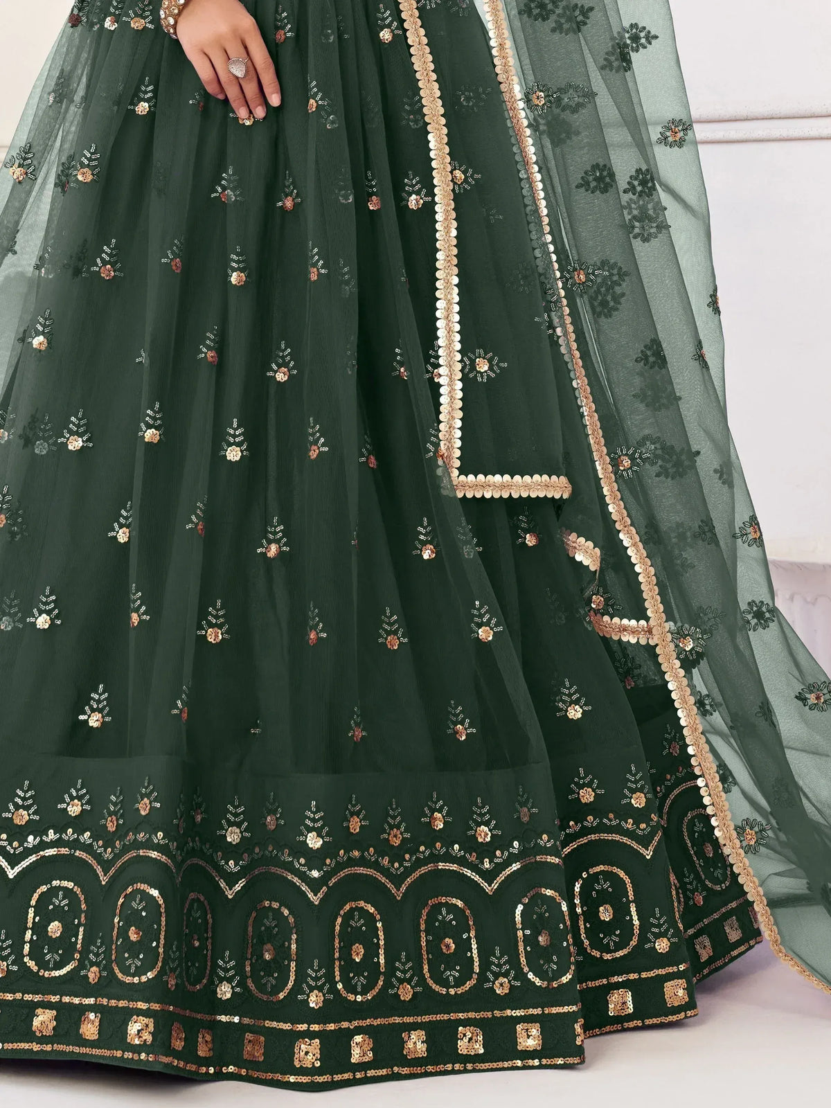 Emerald green embroidered lehenga with gold sequin floral motifs and scalloped border, ideal for Indian weddings.