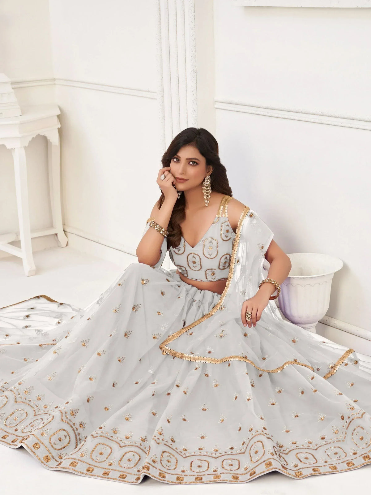 Elegant light blue lehenga choli with gold embroidery, perfect for weddings and festive occasions.