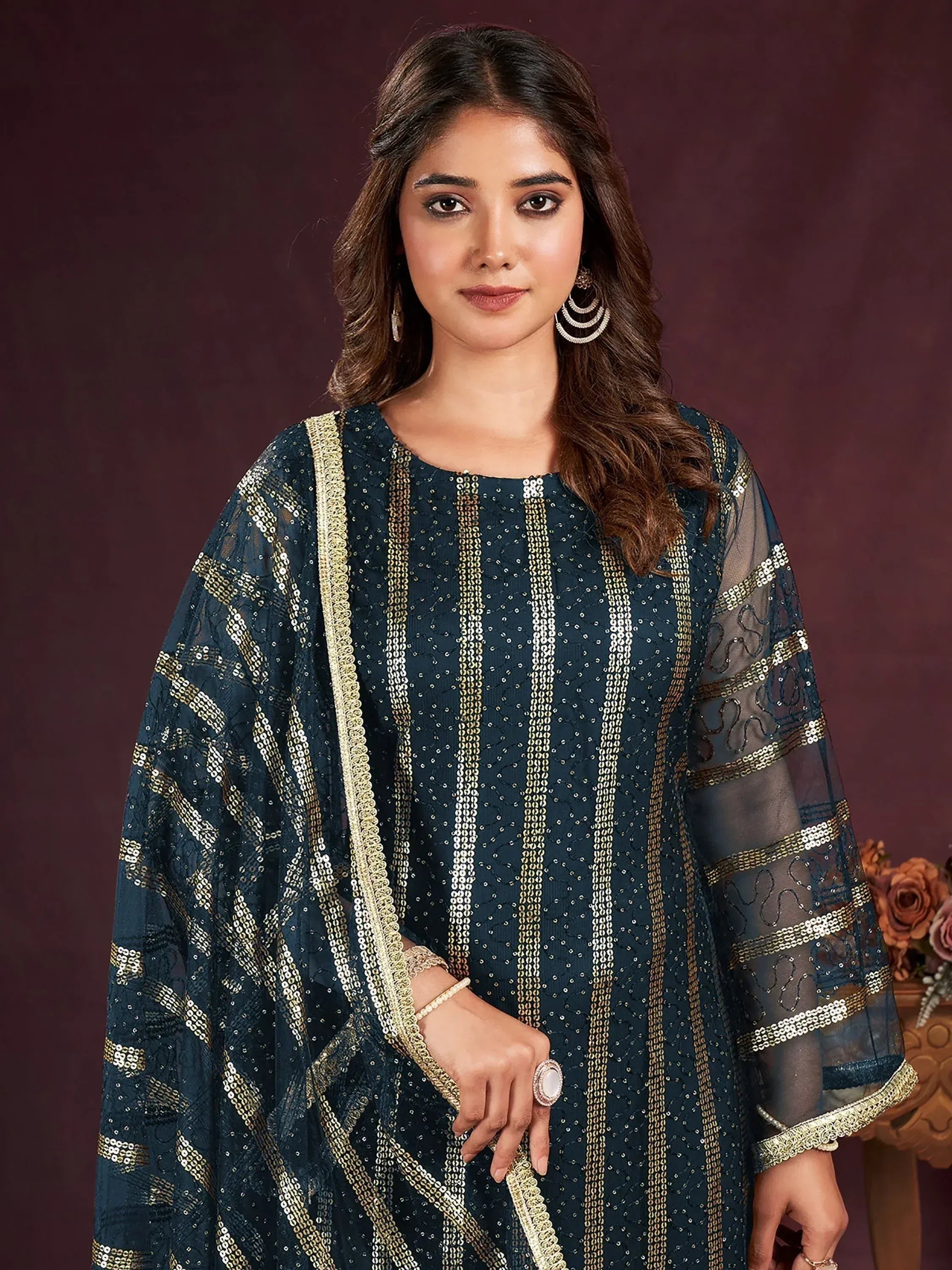 Elegant navy blue ethnic kurta with gold sequin embroidery and sheer sleeves, perfect for festive occasions.