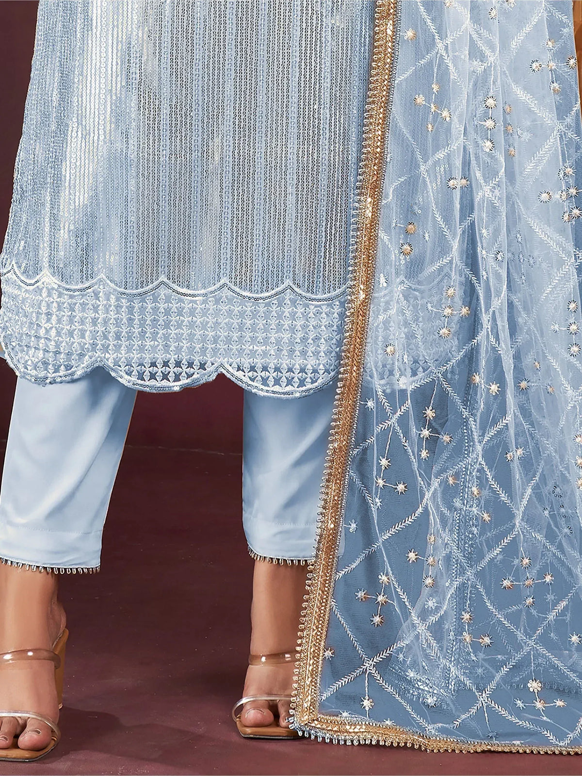 Light blue embroidered salwar kameez with scalloped hem and gold-trimmed dupatta, perfect for ethnic occasions.
