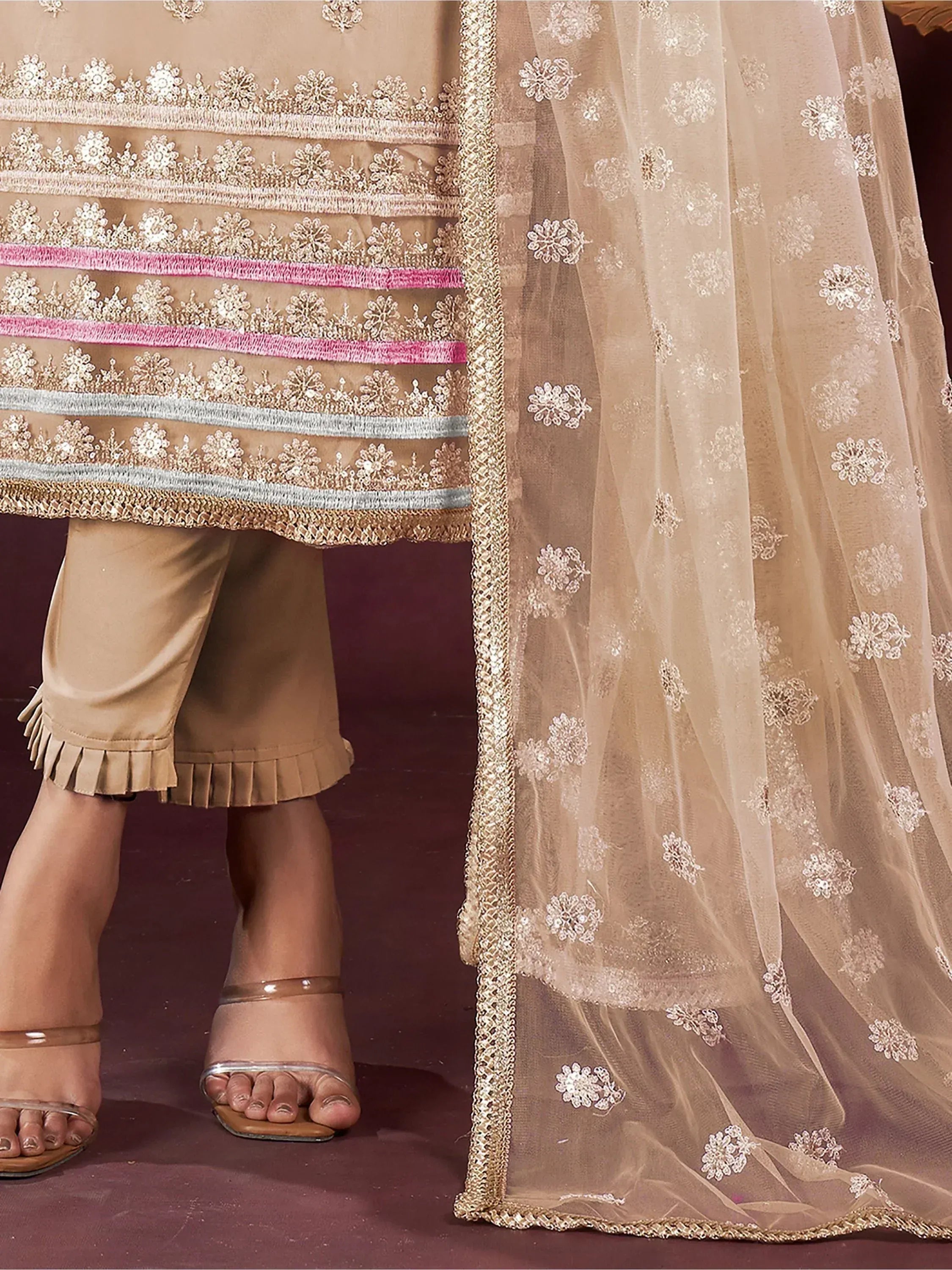 Elegant beige salwar kameez with floral embroidery and sheer dupatta, perfect for ethnic occasions.