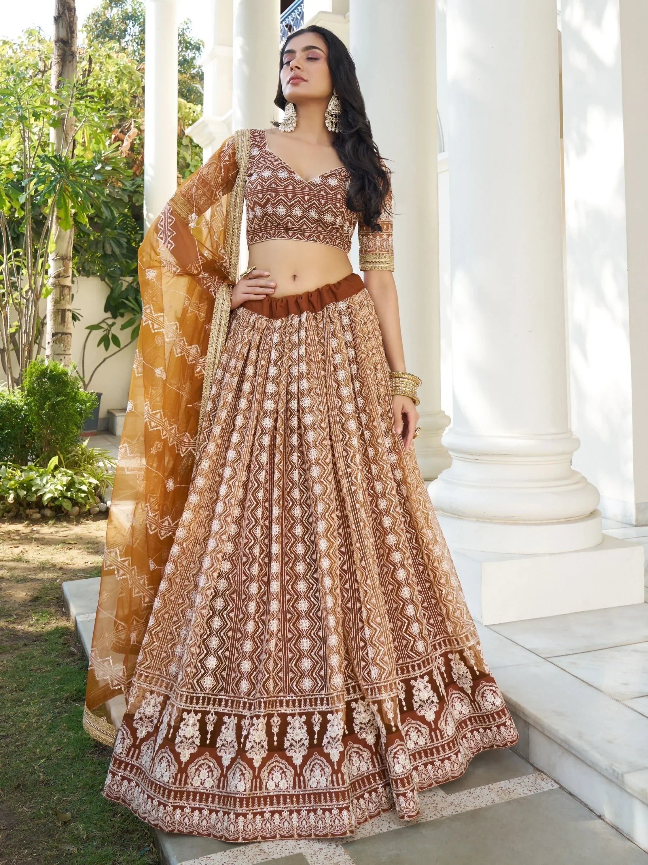 Brown and gold embroidered lehenga choli with geometric print, perfect for Indian ethnic wear occasions.