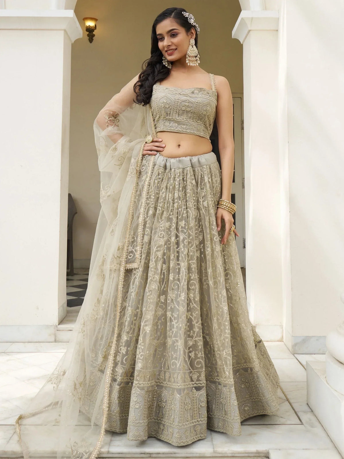 Elegant beige embroidered lehenga choli with sheer dupatta, perfect for Indian weddings and festive occasions.