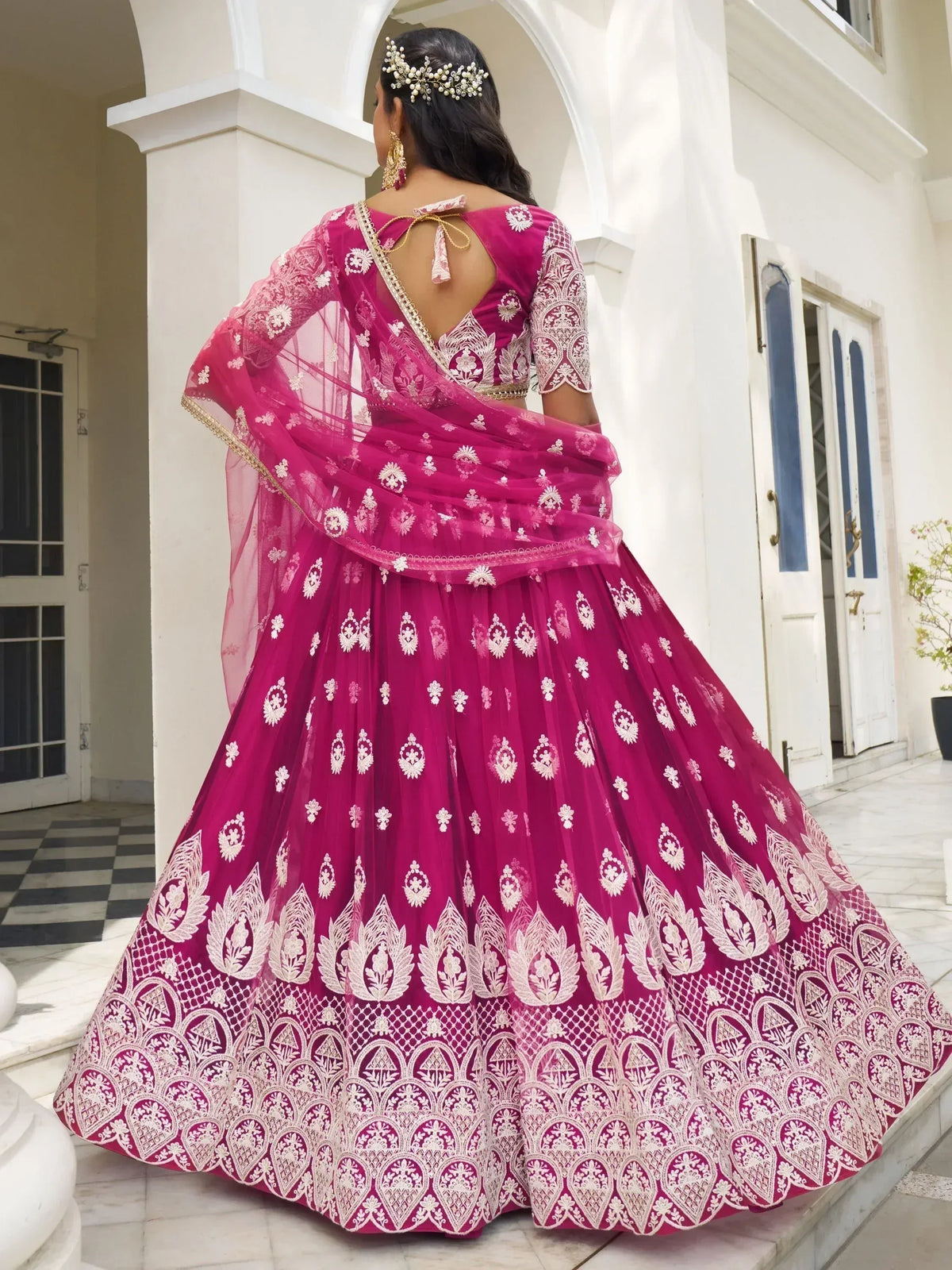 Pink embroidered lehenga choli with gold detailing, perfect for Indian weddings and festive occasions.