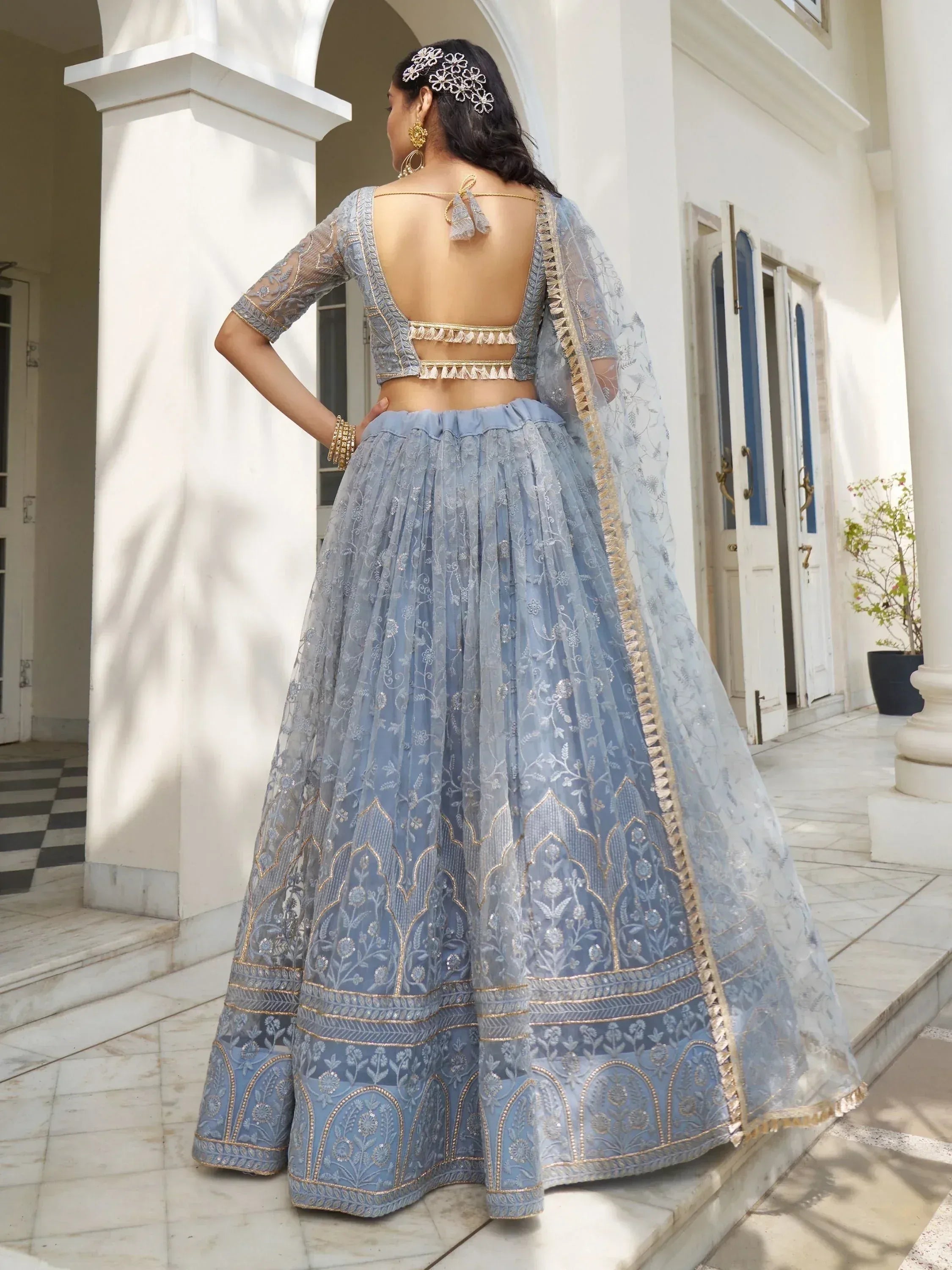 Elegant blue embroidered lehenga choli with sheer dupatta, perfect for Indian weddings and festive occasions.