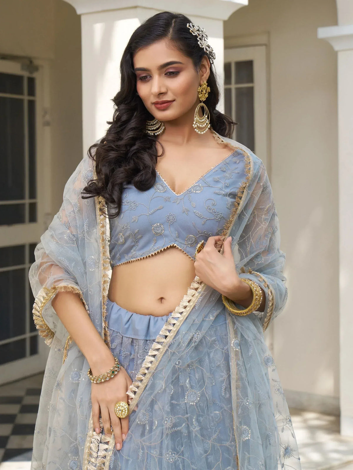 Elegant light blue embroidered lehenga choli with gold detailing, perfect for Indian ethnic wear occasions.