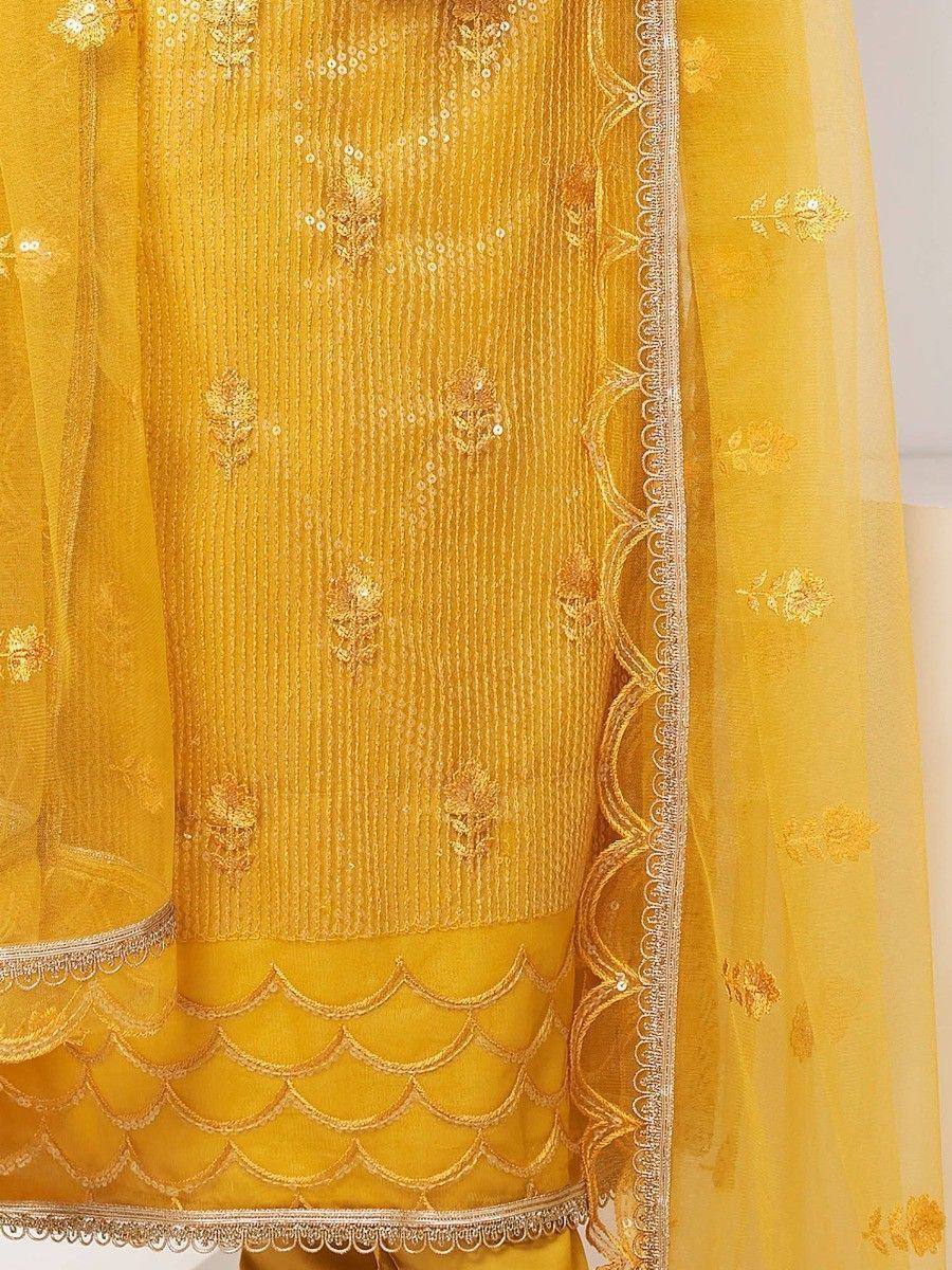 Yellow ethnic salwar kameez with gold embroidery and scalloped hem, perfect for festive occasions
