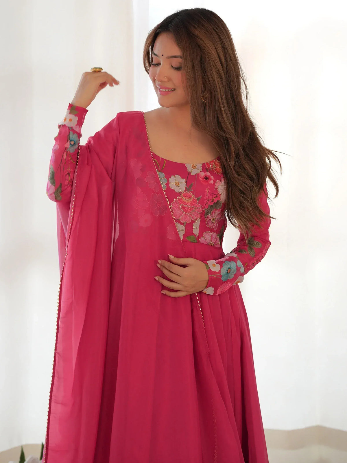 Pink floral embroidered ethnic gown with sheer dupatta, perfect for Indian occasions and festive wear.
