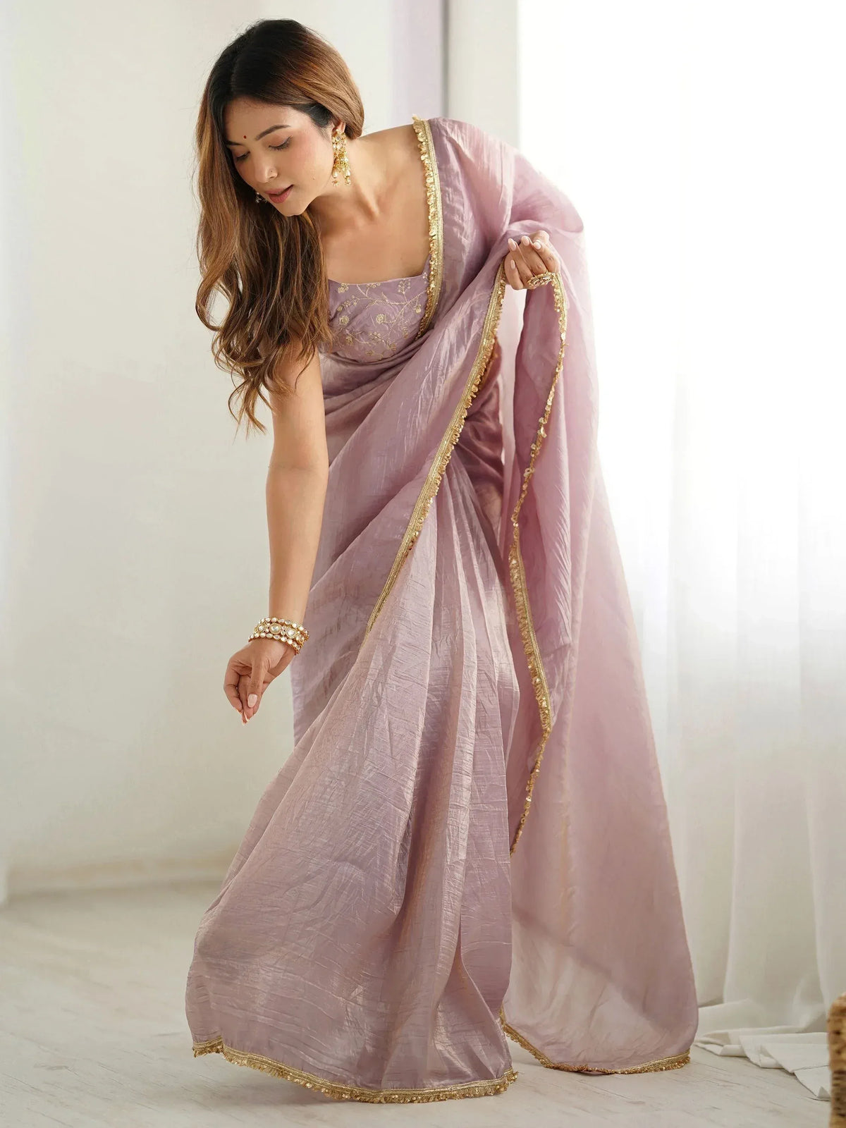 Elegant lavender saree with gold trim, perfect for Indian ethnic wear and festive occasions.
