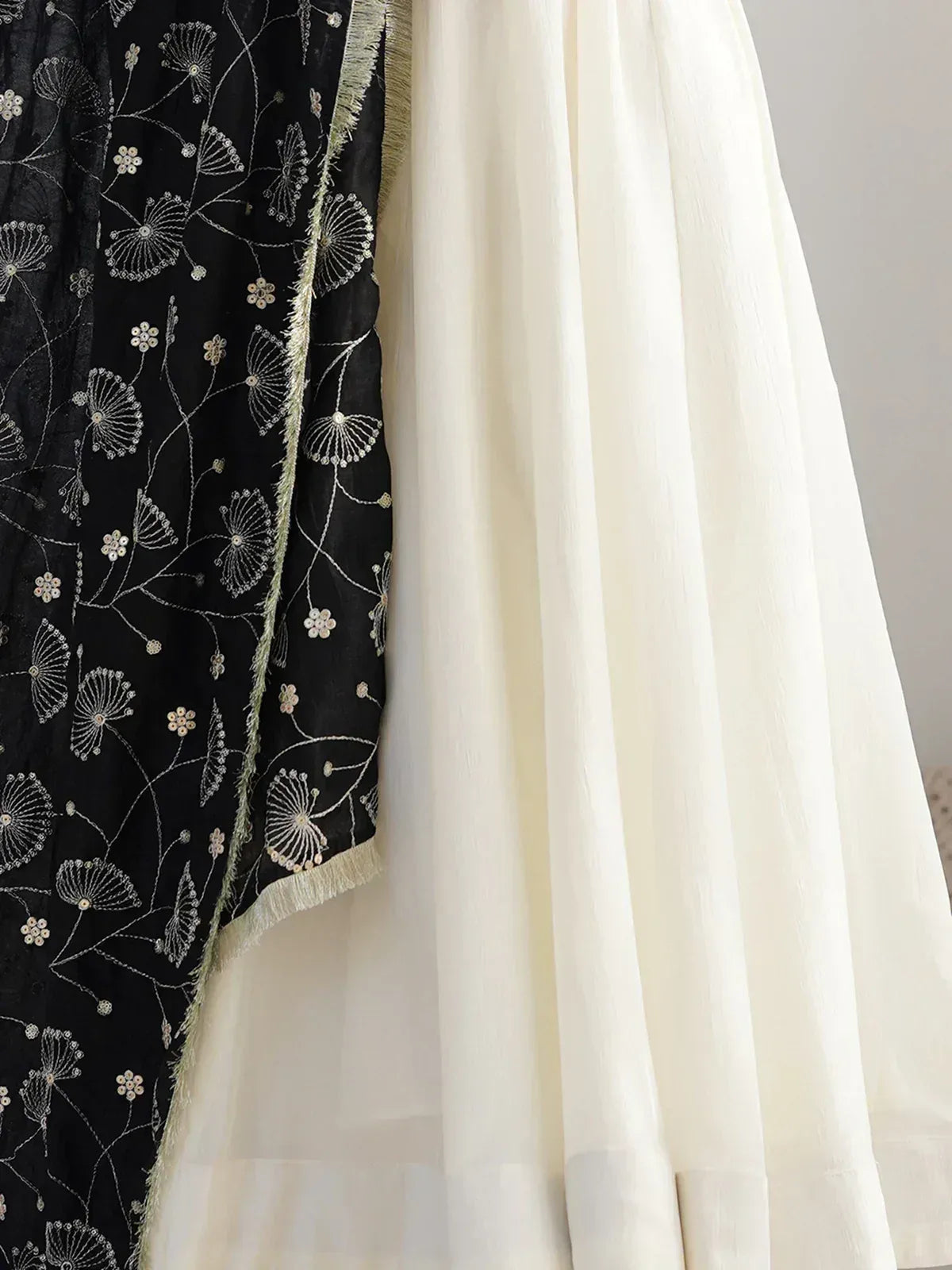 Black embroidered dupatta with floral motifs paired with cream ethnic gown