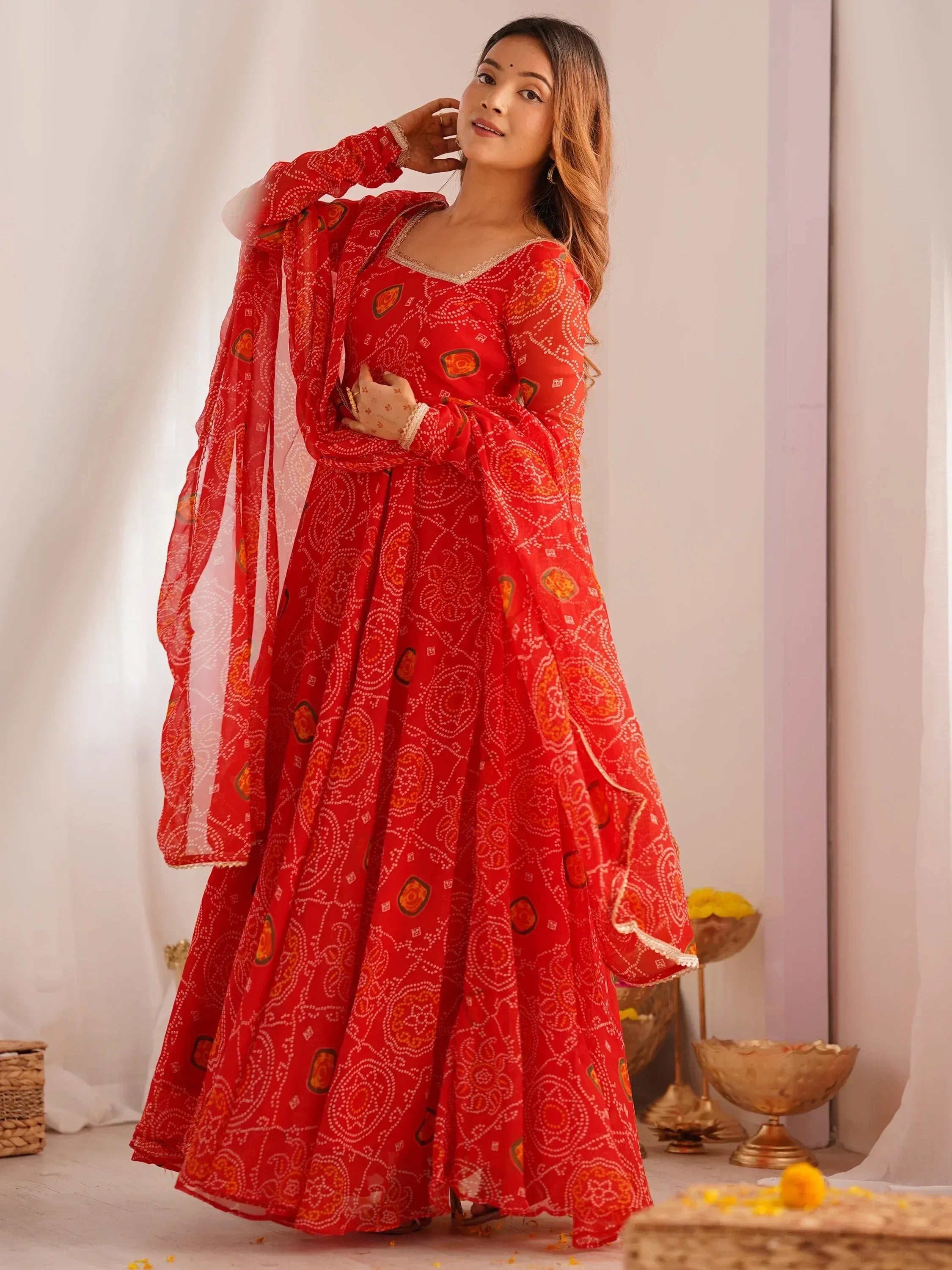 Red printed ethnic anarkali gown with flared sleeves and dupatta, perfect for Indian occasions