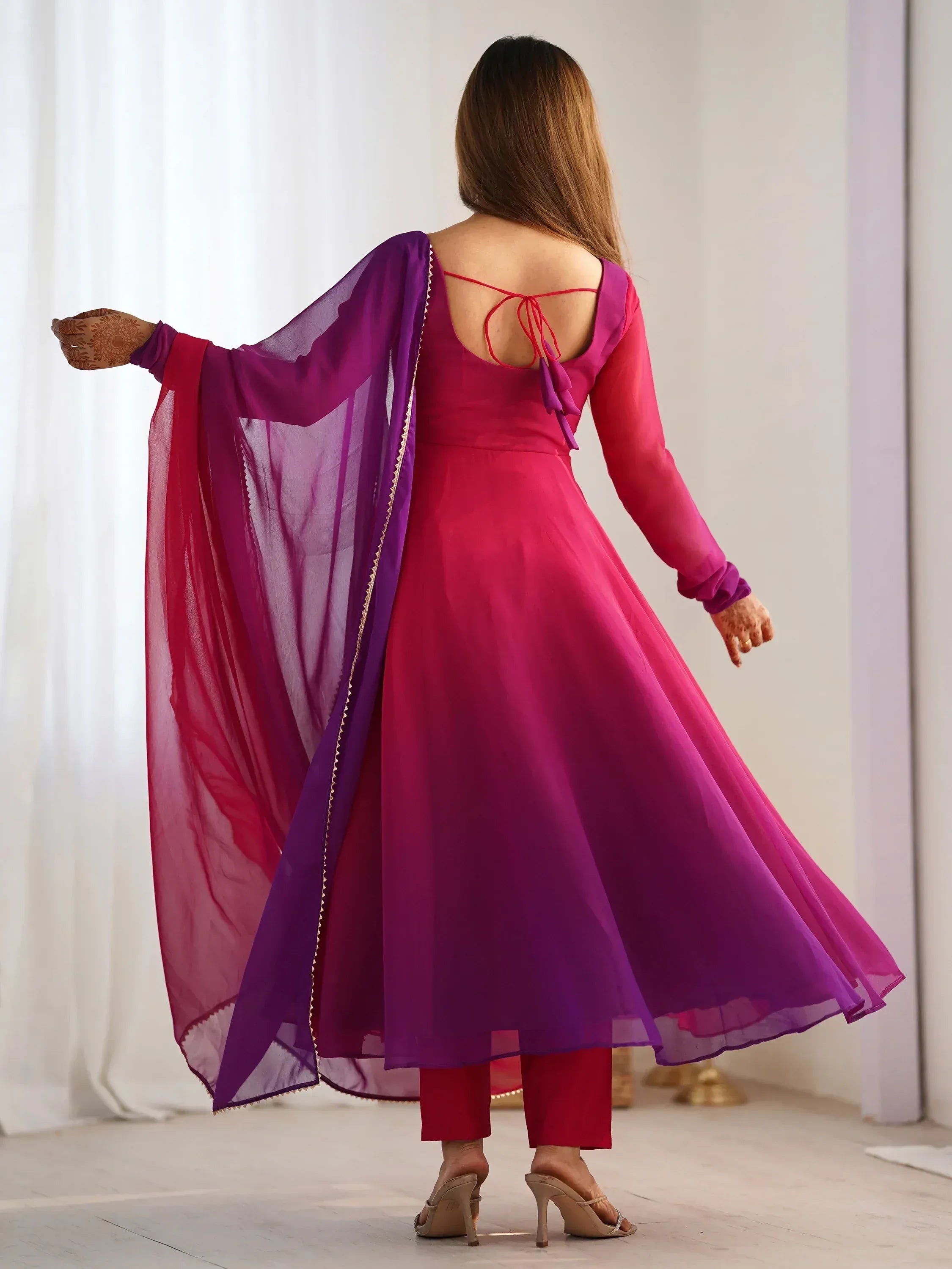 Woman in pink and purple ethnic anarkali with back tie detail and sheer dupatta, perfect for festive occasions