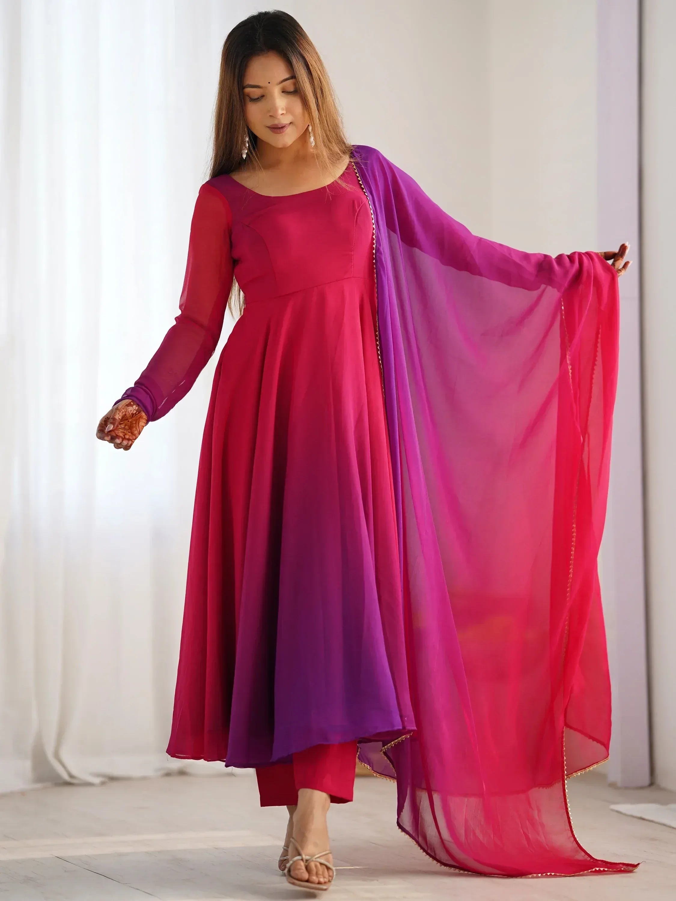 Woman in vibrant pink and purple ombre ethnic gown with matching dupatta, ideal for Indian occasions