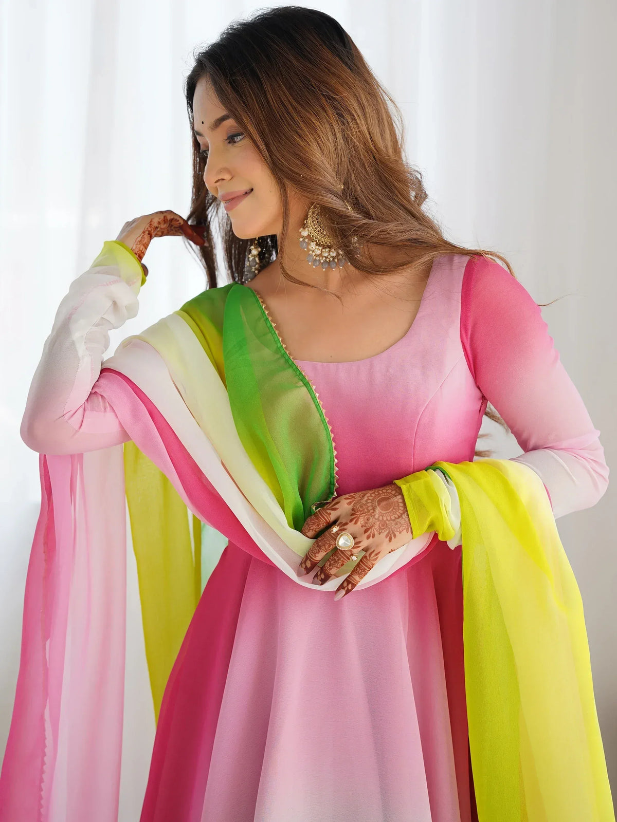 Pink and green Indian ethnic anarkali with ombre dupatta, henna hands, and gold jewelry