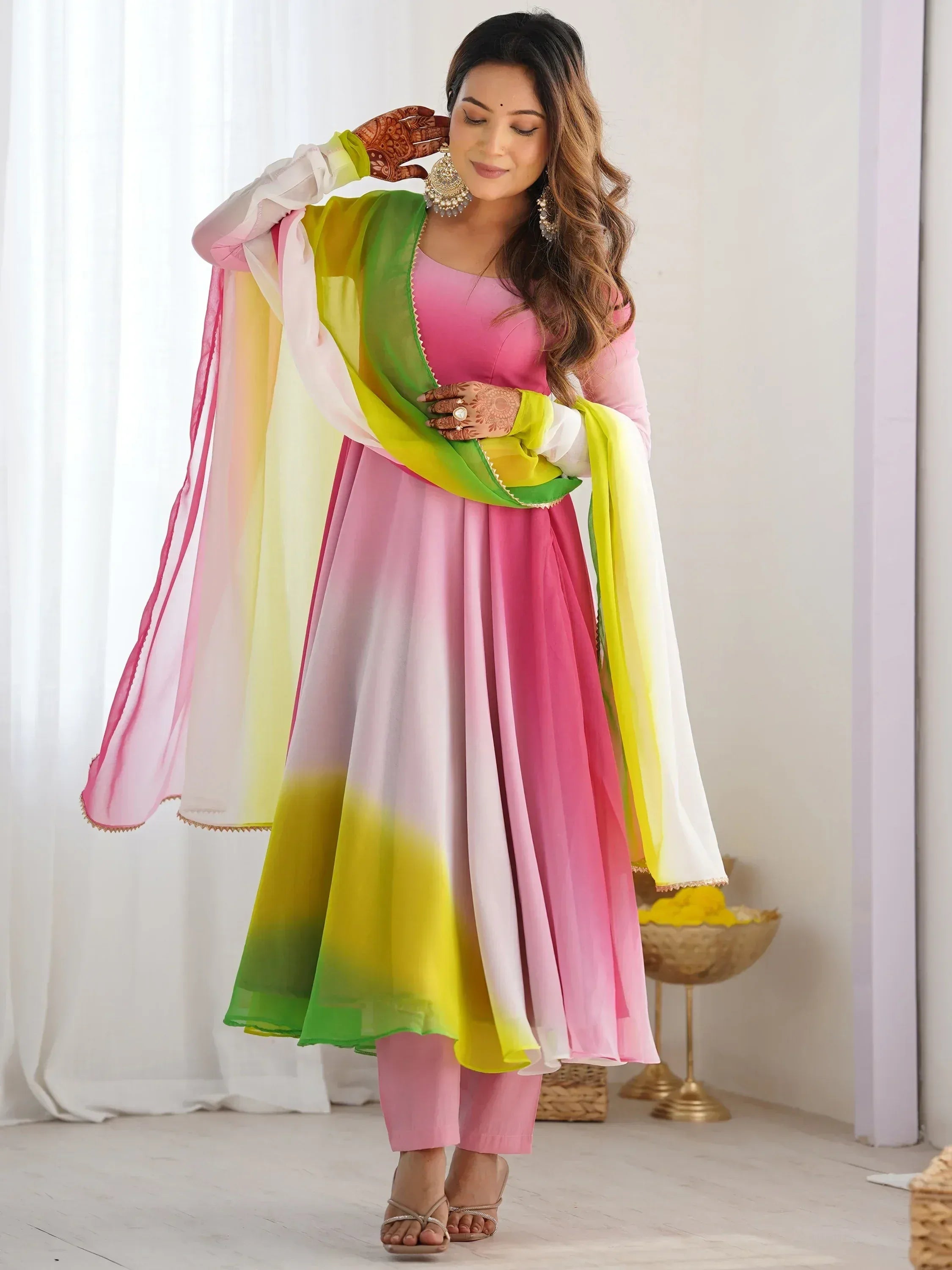 Woman in vibrant pink and green ombre Indian ethnic anarkali suit with dupatta, perfect for festive occasions