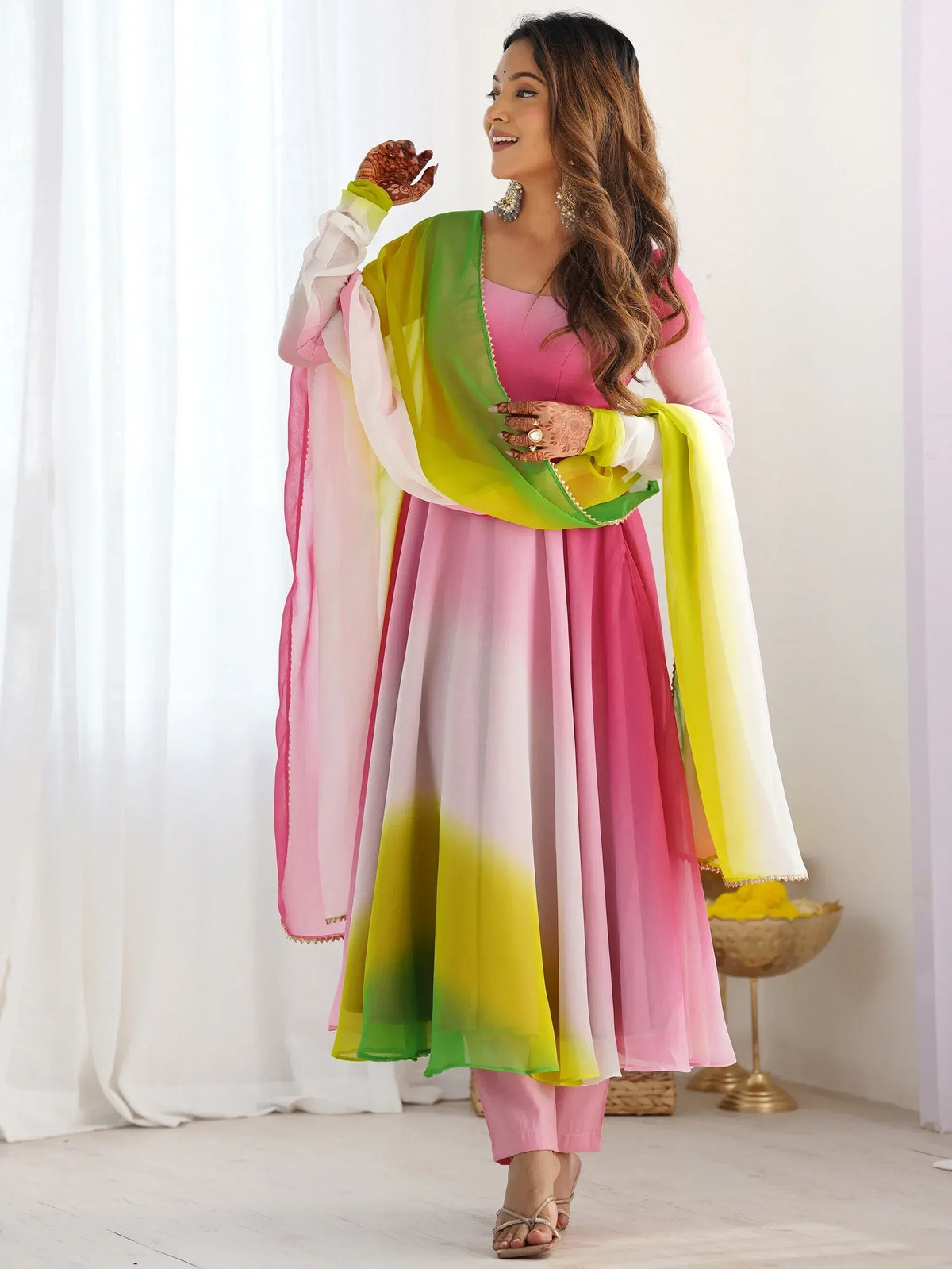 Woman in pink and green ombre Indian ethnic salwar kameez with dupatta, perfect for festive occasions