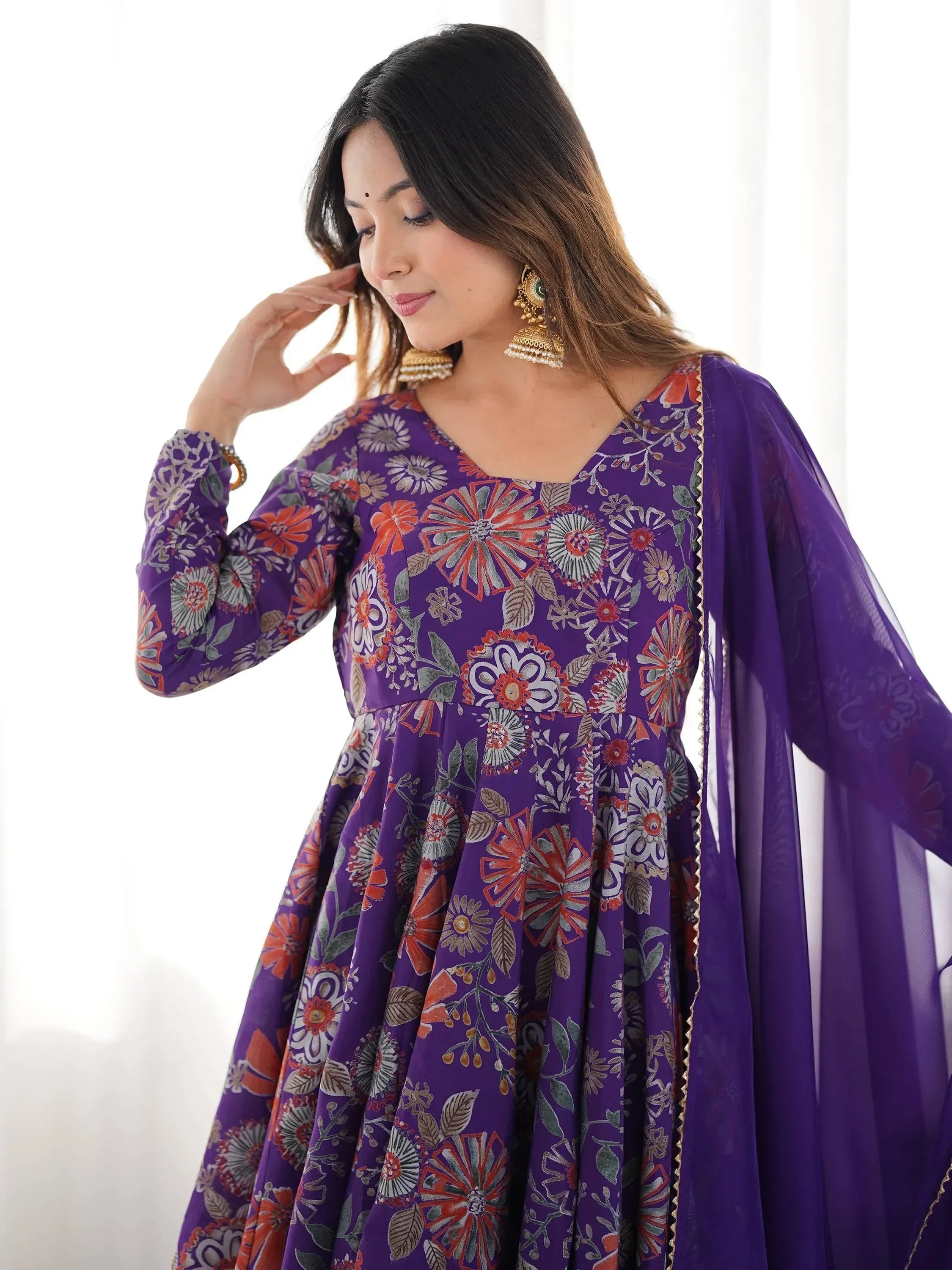 Purple floral print ethnic gown with sheer sleeves, perfect for Indian occasions and festive wear.