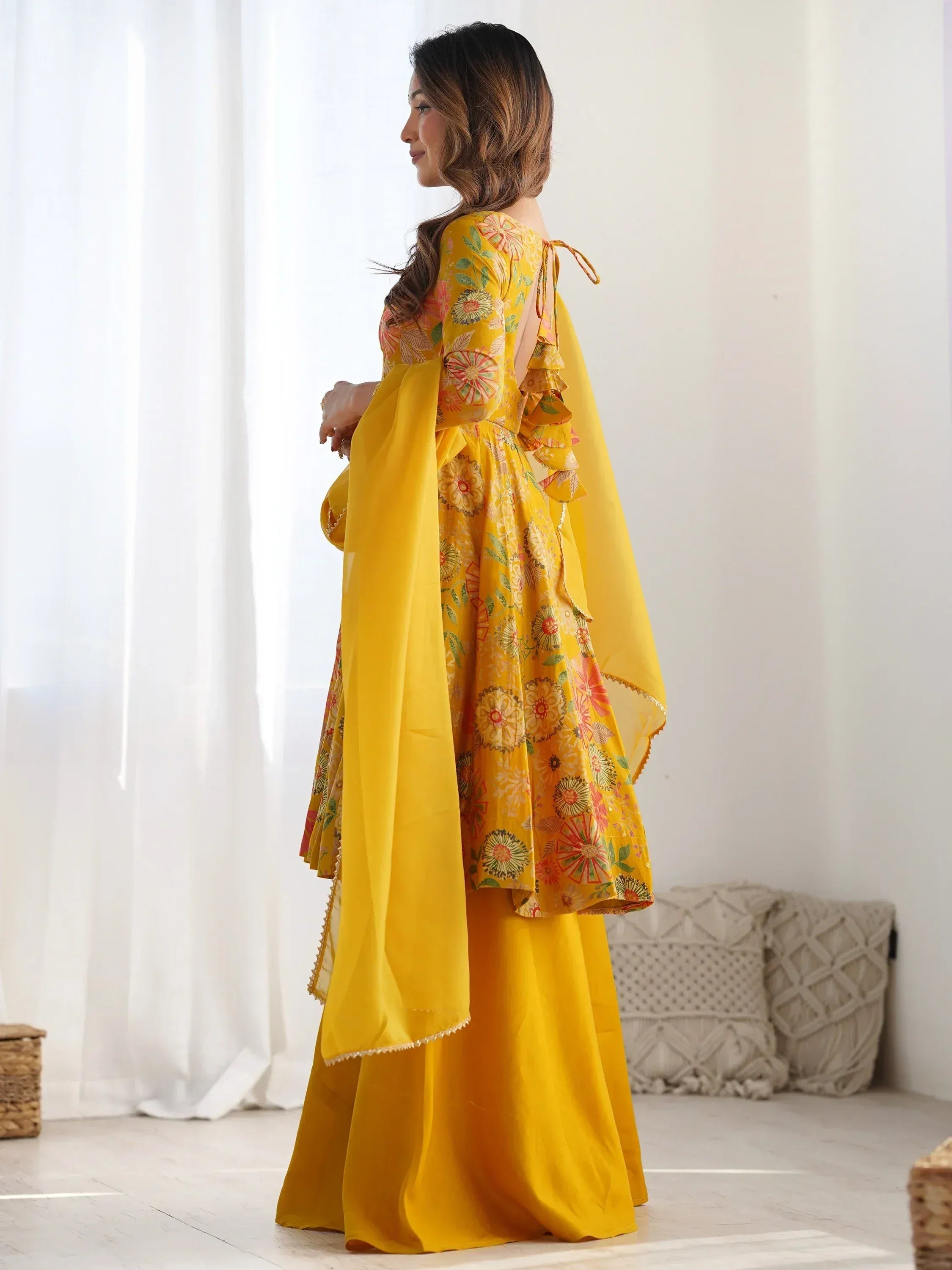 Yellow floral printed ethnic gown with ruffled sleeves and back tie, paired with matching palazzo and dupatta