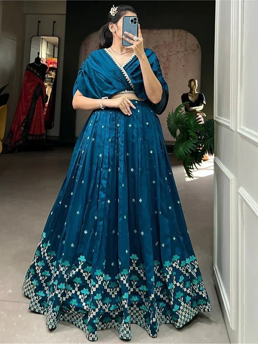 Teal blue lehenga choli with floral border, perfect for Indian ethnic wear occasions