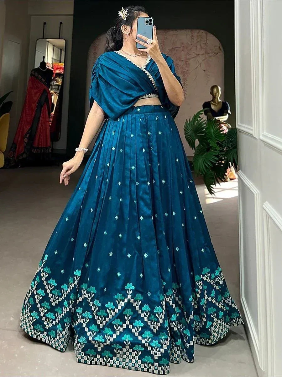 Teal blue designer lehenga choli with floral border, perfect for Indian ethnic wear occasions