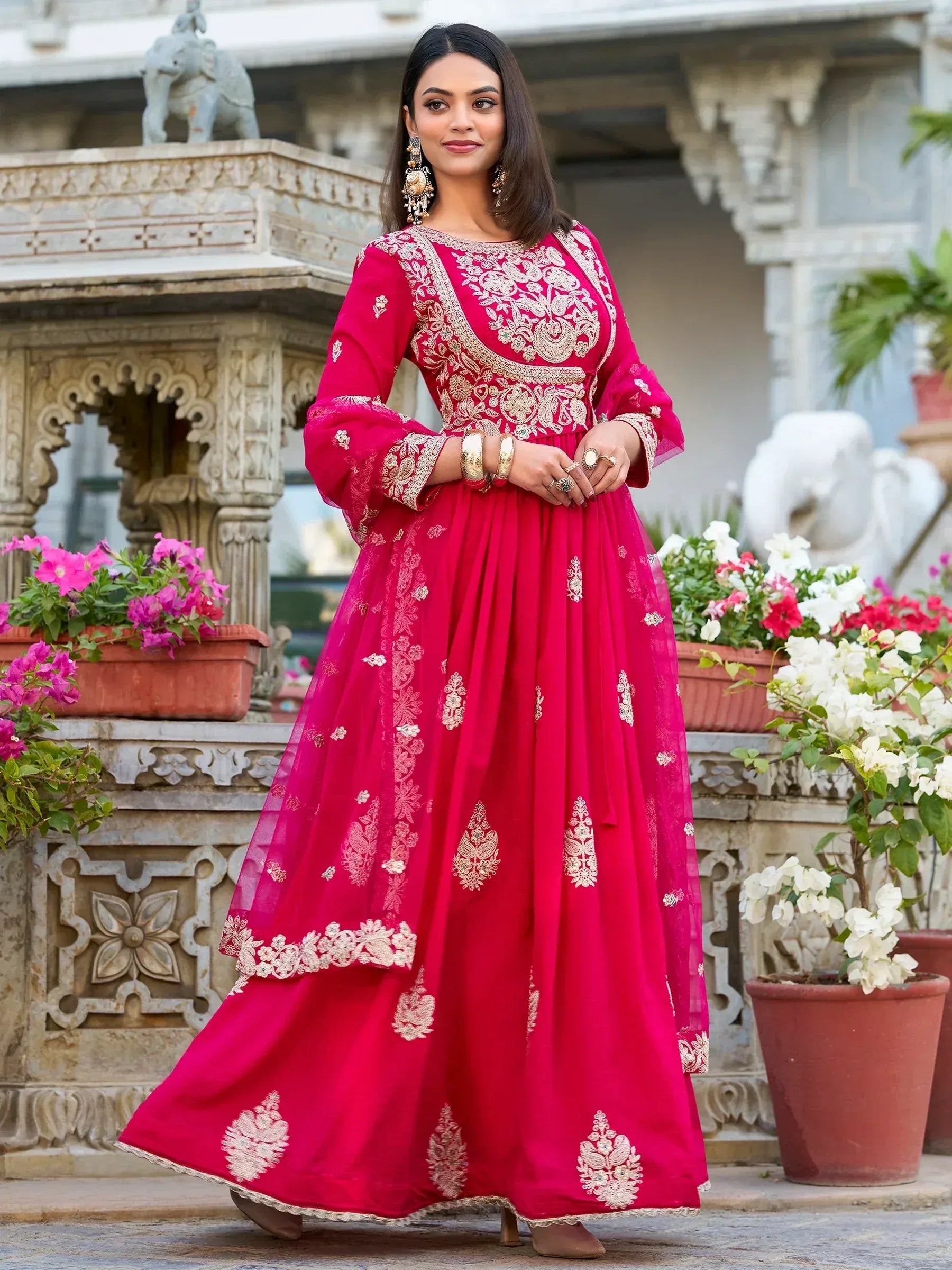 Elegant pink embroidered anarkali gown with gold detailing, perfect for Indian ethnic occasions.