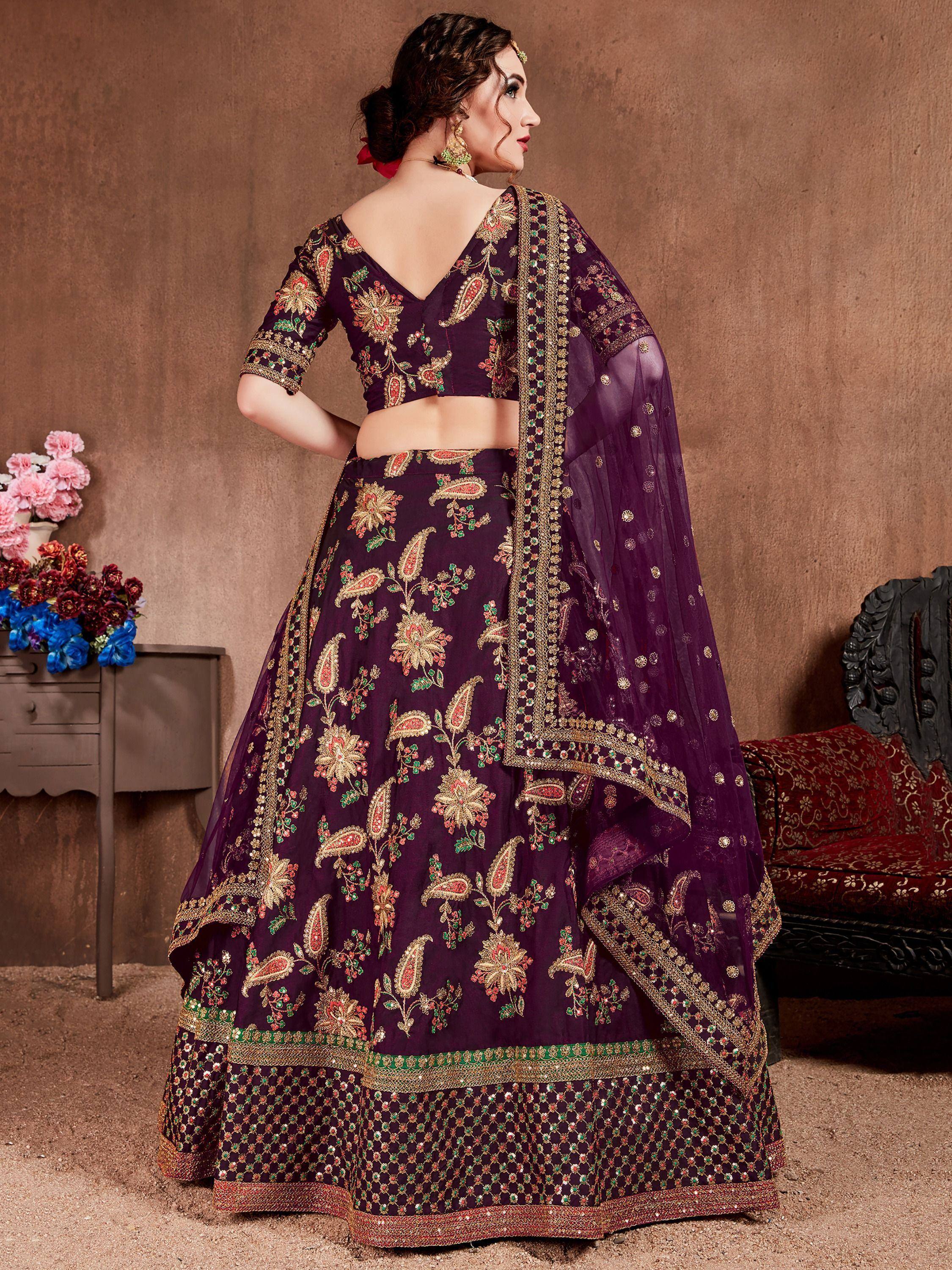 Purple embroidered lehenga choli with floral and paisley motifs, perfect for Indian weddings and festive occasions.
