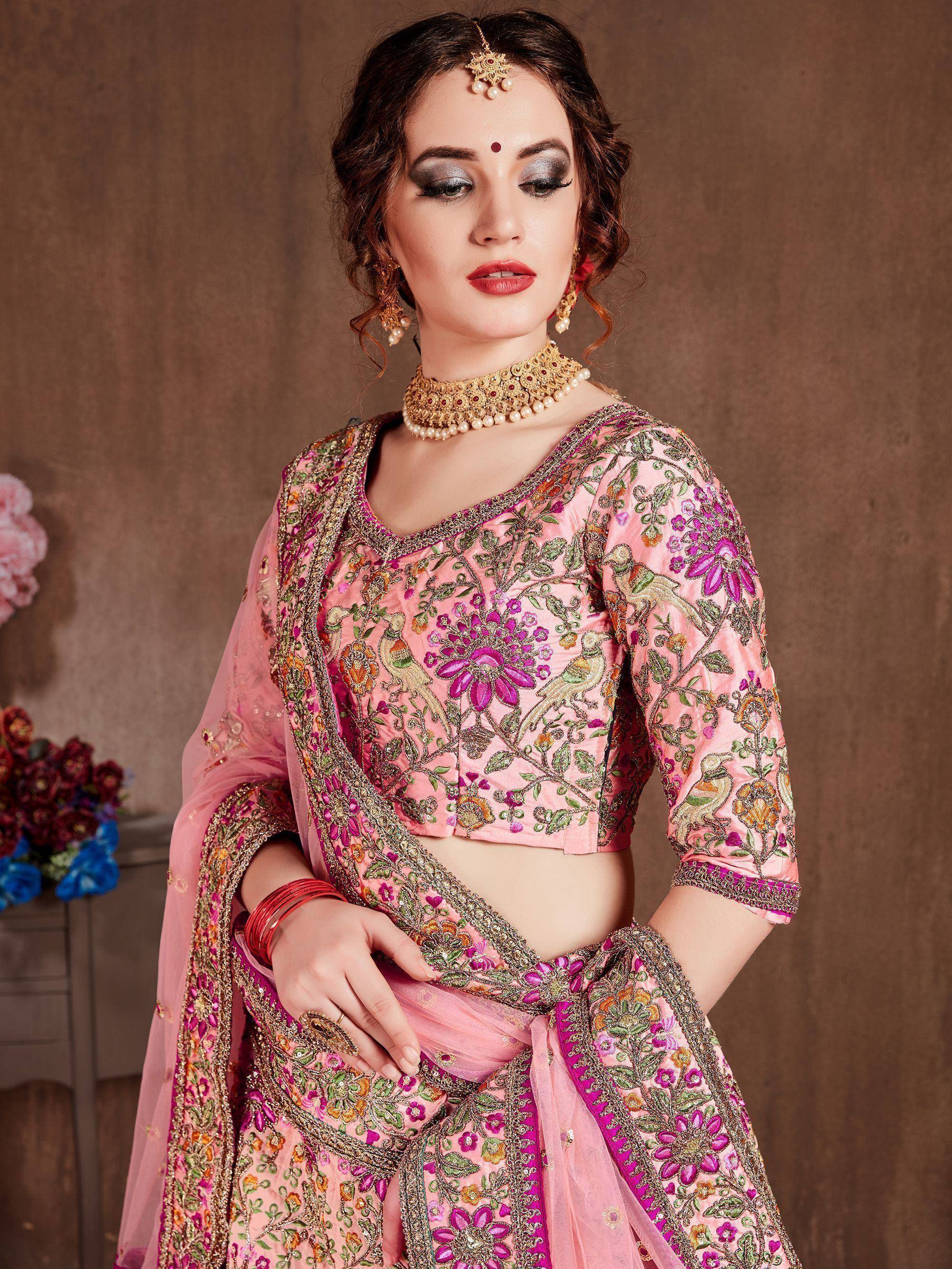 Pink embroidered lehenga choli with floral and bird motifs, traditional Indian ethnic wear for women