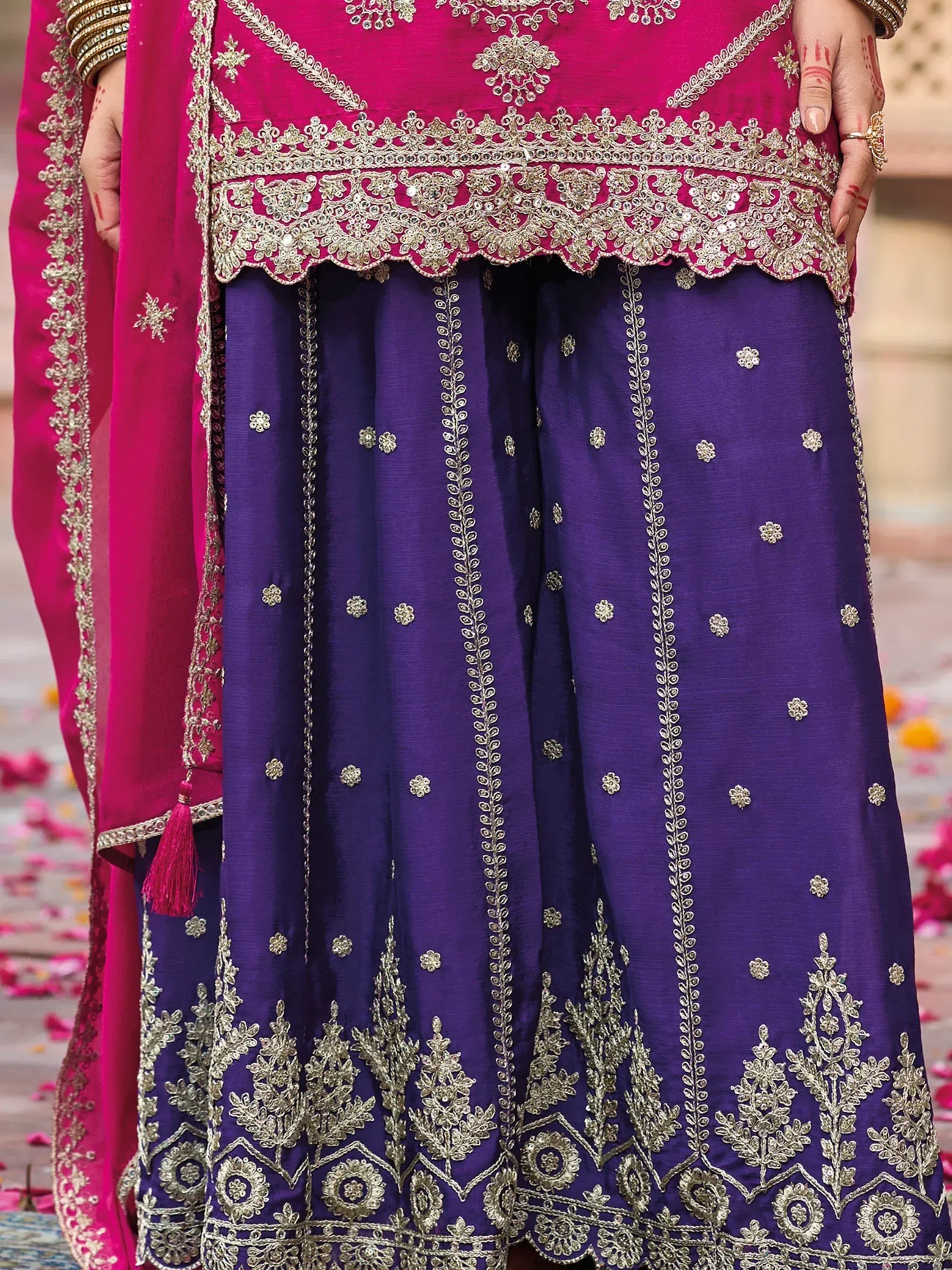 Pink and purple designer lehenga choli with gold embroidery, perfect for Indian weddings and festive occasions.