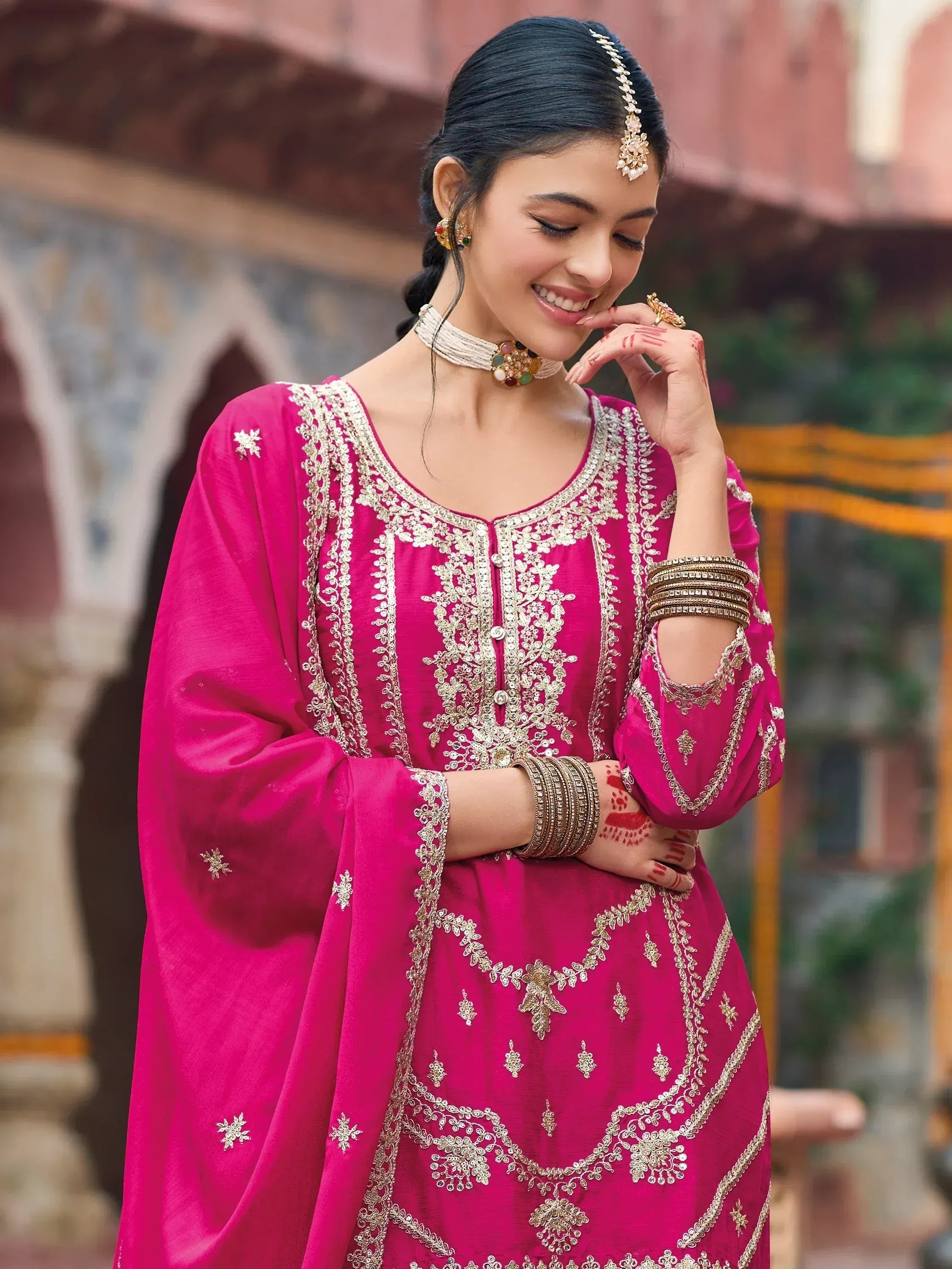 Pink embroidered ethnic gown with gold detailing, perfect for Indian festive occasions and weddings