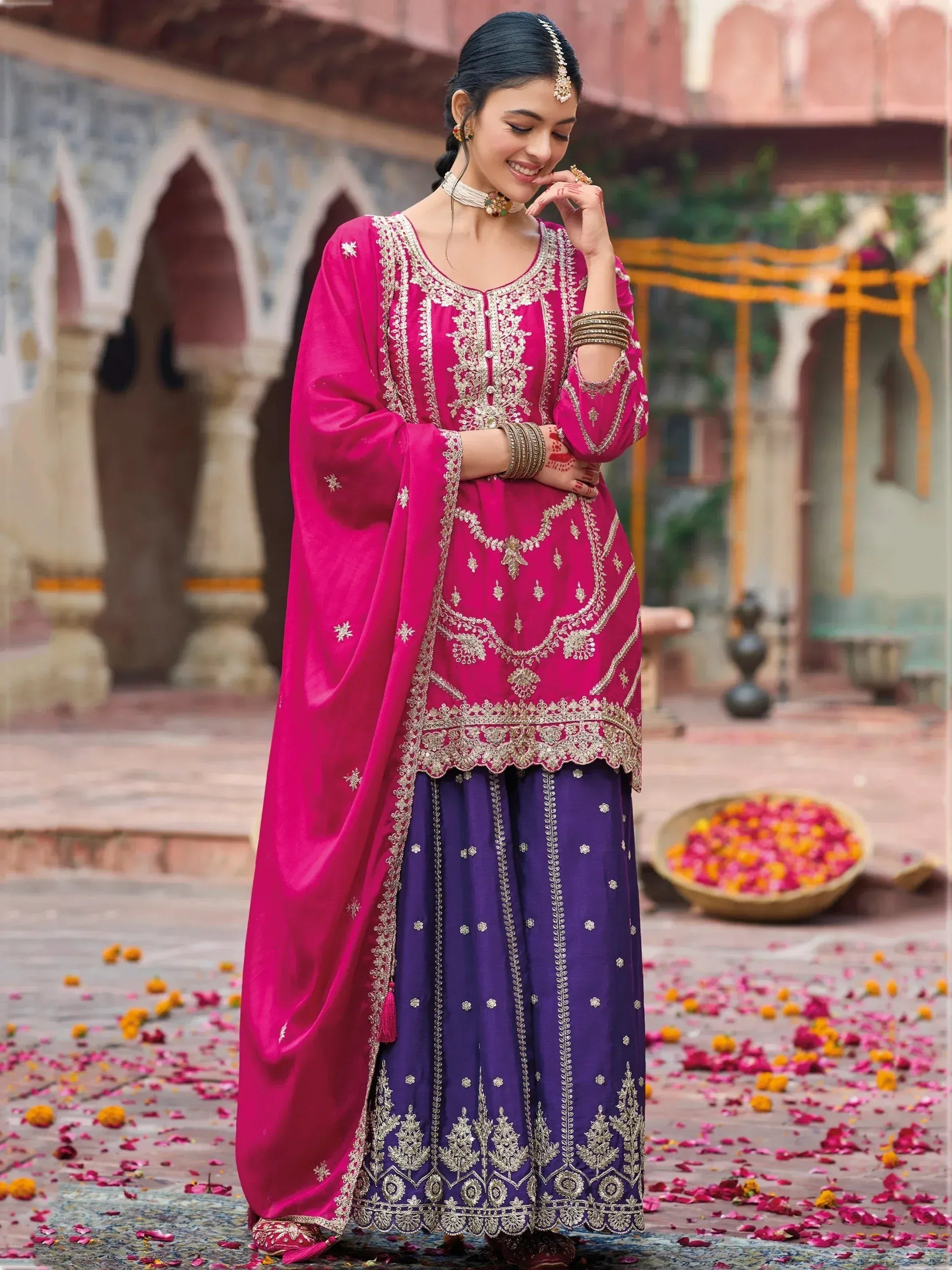 Pink and purple embroidered Indian salwar kameez with gold detailing, perfect for festive occasions