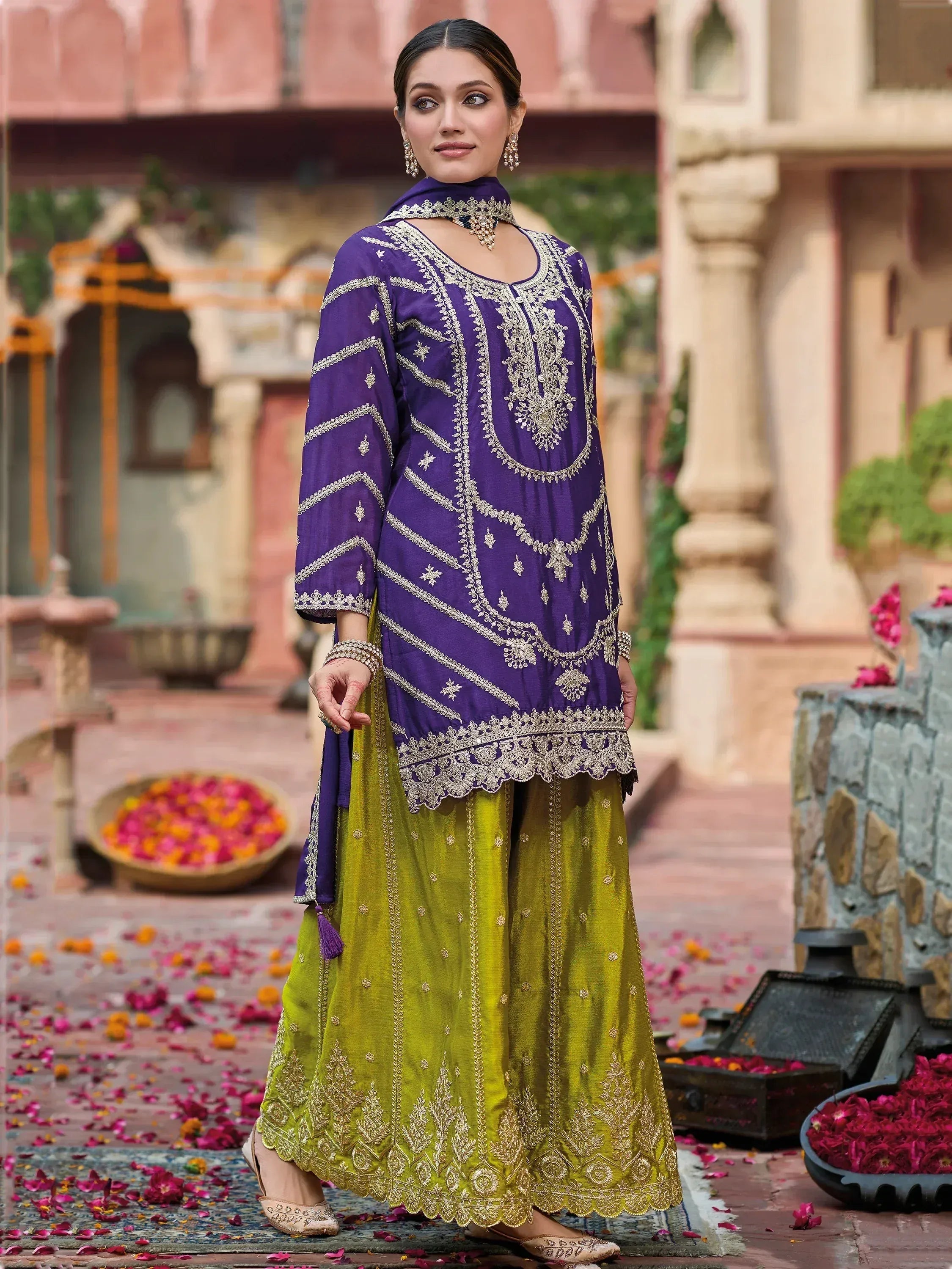 Purple and green embroidered salwar kameez with gold detailing, perfect for festive occasions