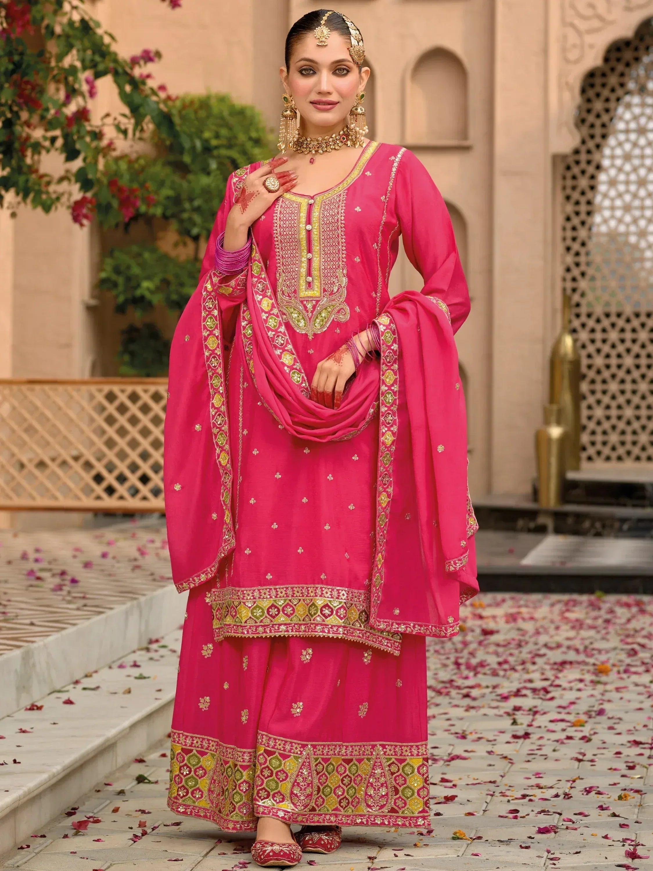 Pink embroidered salwar kameez with gold detailing, perfect for Indian ethnic wear and festive occasions.