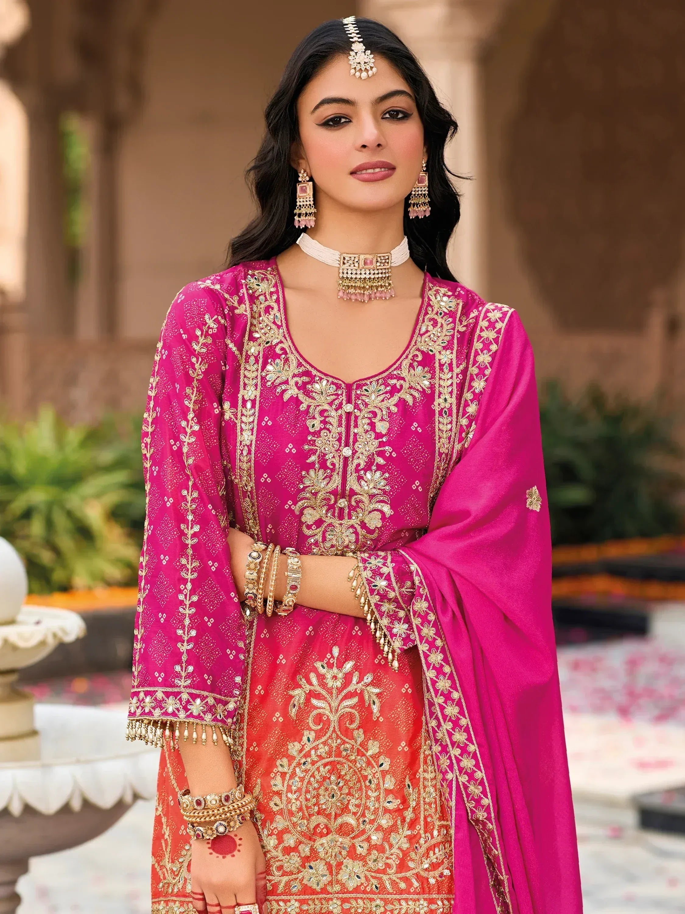 Pink and orange embroidered salwar kameez with gold detailing, perfect for Indian ethnic wear occasions.