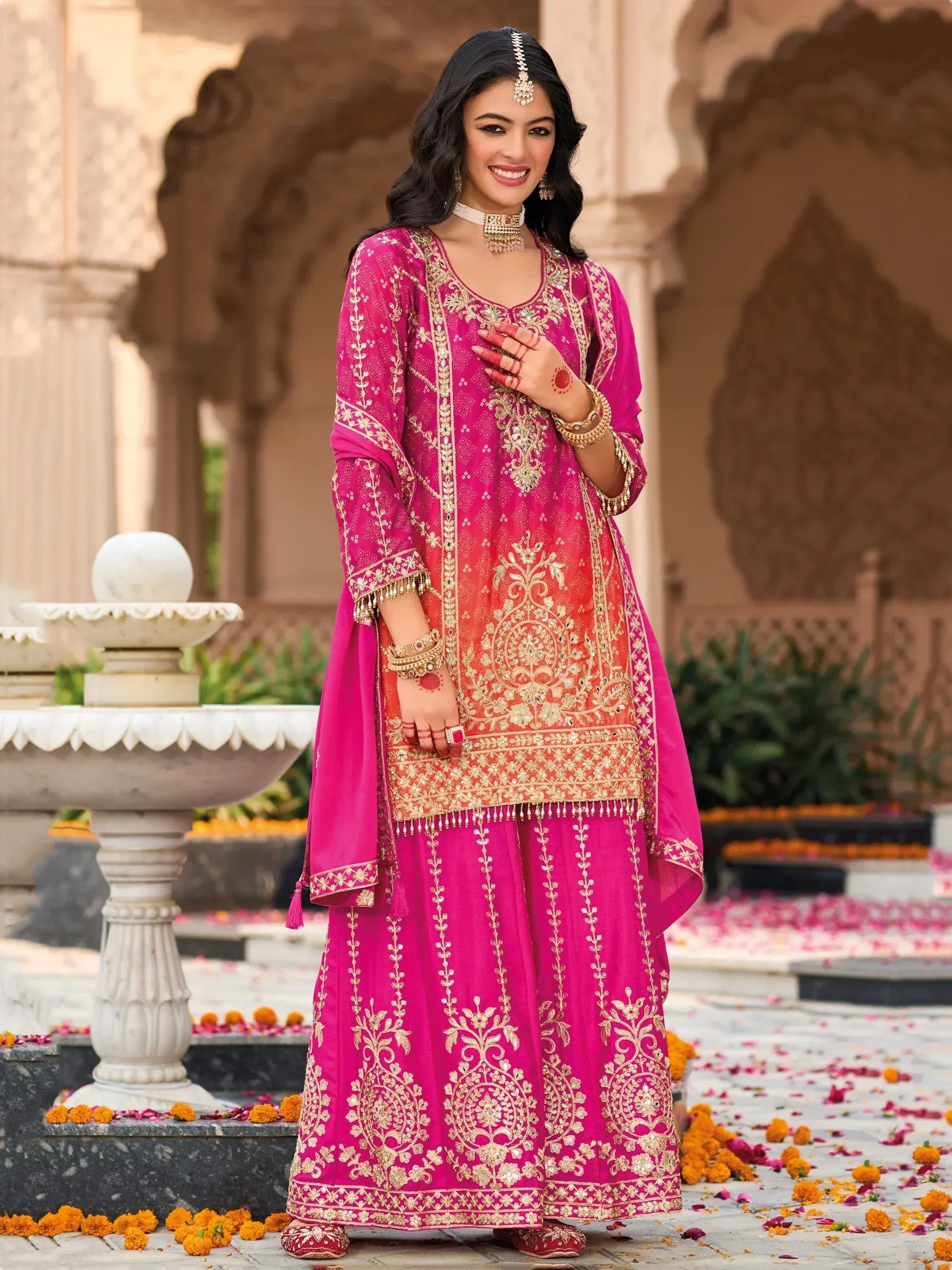Pink embroidered salwar kameez with gold detailing, perfect for Indian ethnic occasions and weddings.